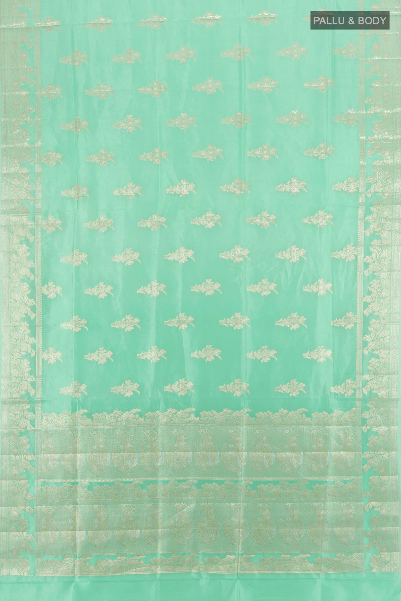 Flat view of Sea Green Banarasi Raw Silk Saree with Zari Butta on the body and Zari Border. 
