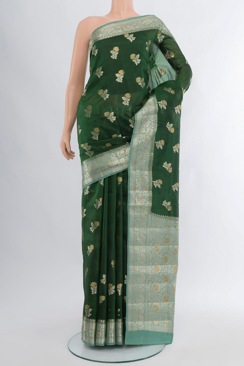 Bottle Green Banarasi Raw Silk Saree with Zari Butta on the body and Zari Border.  displayed on a mannequin