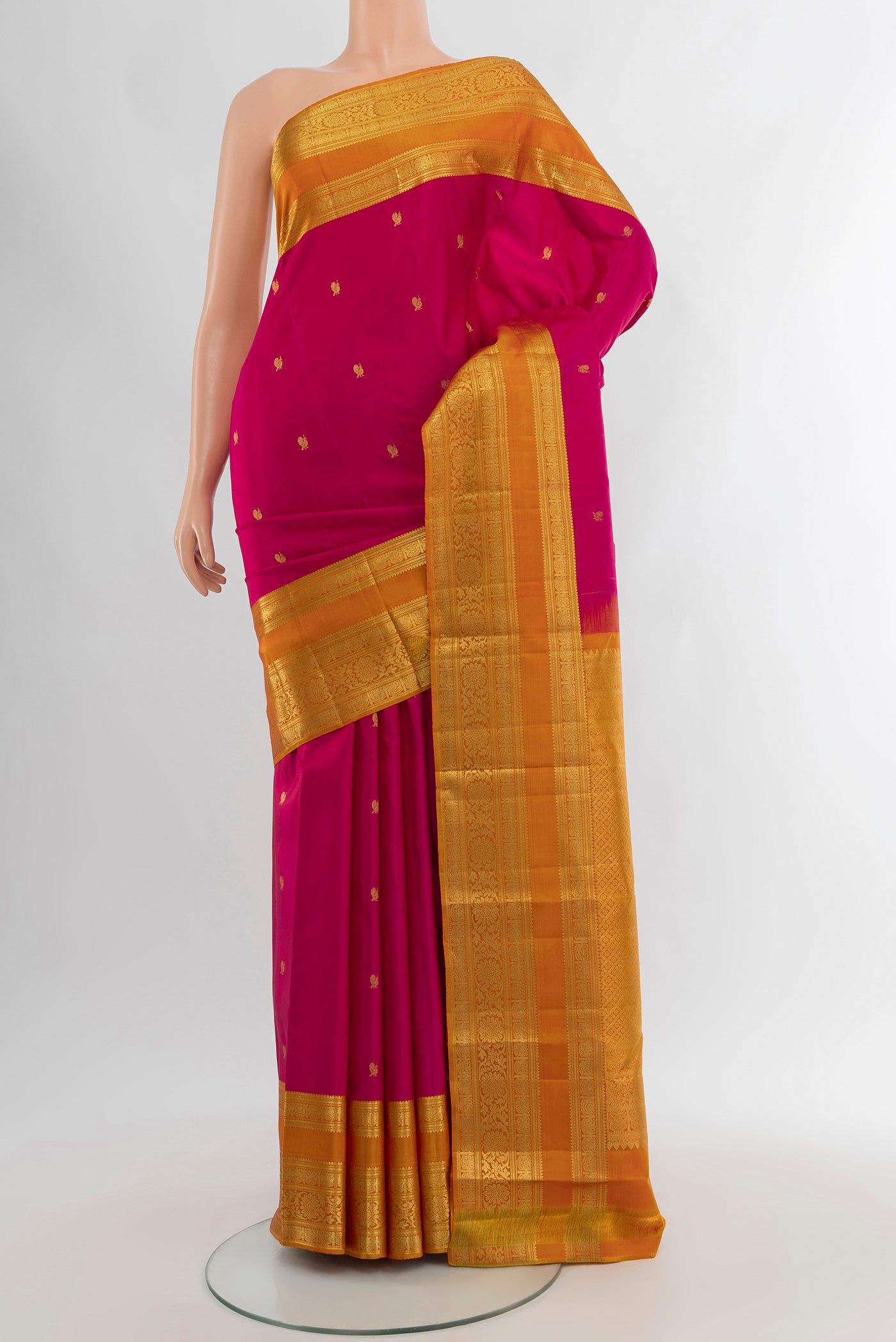 Dark Pink Kanchipuram Silk Saree with Zari Butta on the body and Zari Border.  displayed on a mannequin