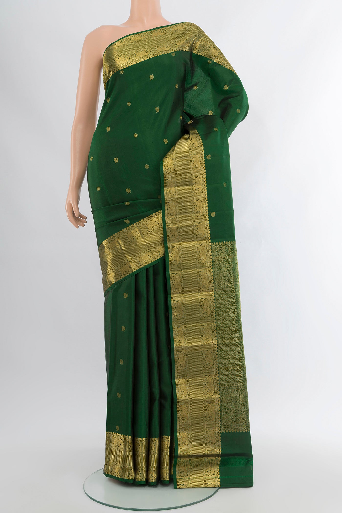 Bottle Green Kanchipuram Silk Saree with Zari Butta on the body and Zari Border.  displayed on a mannequin