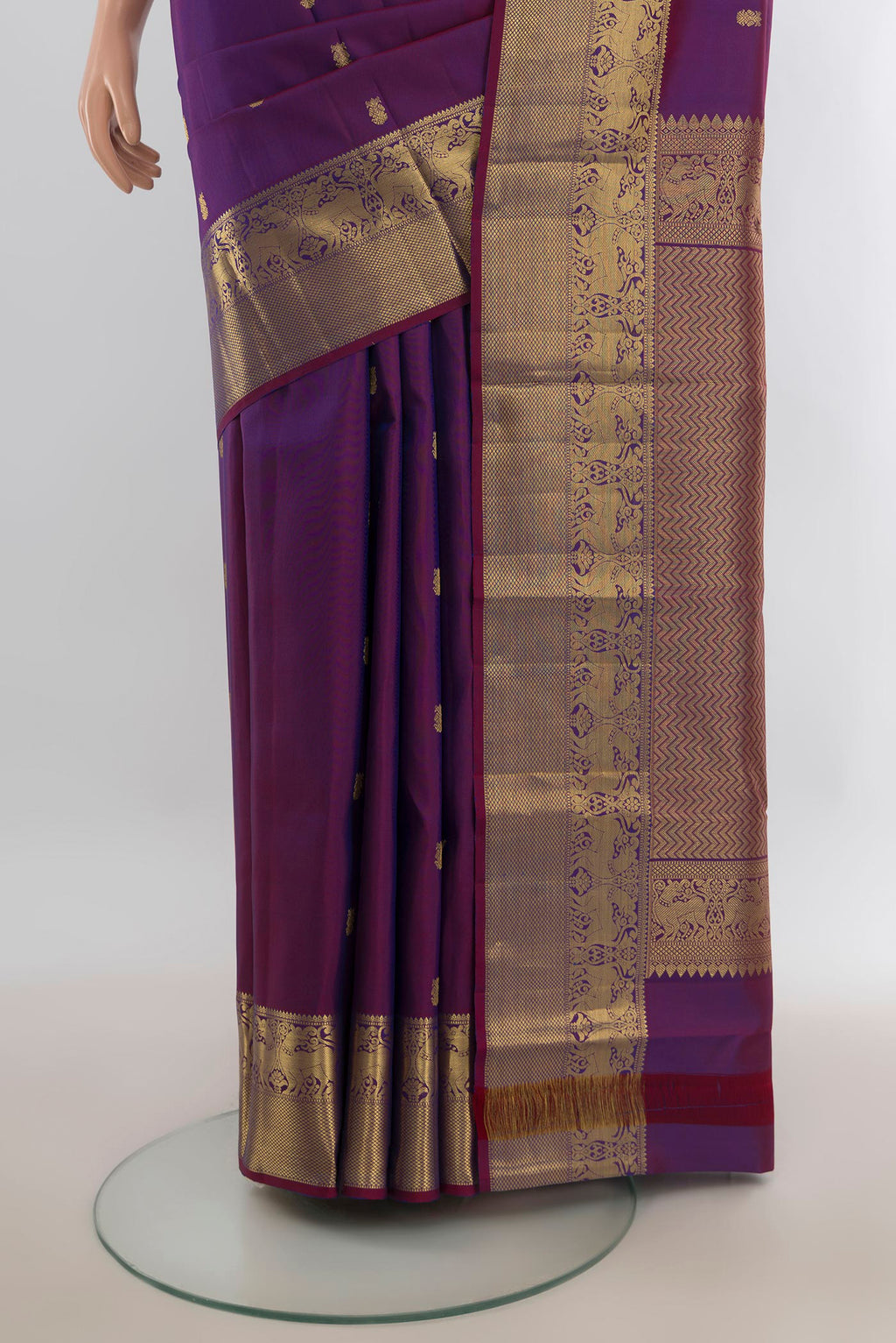 Pleats and pallu of Pure Silk Violet Kanchipuram Saree with Zari Butta on the body and Silk Border. 