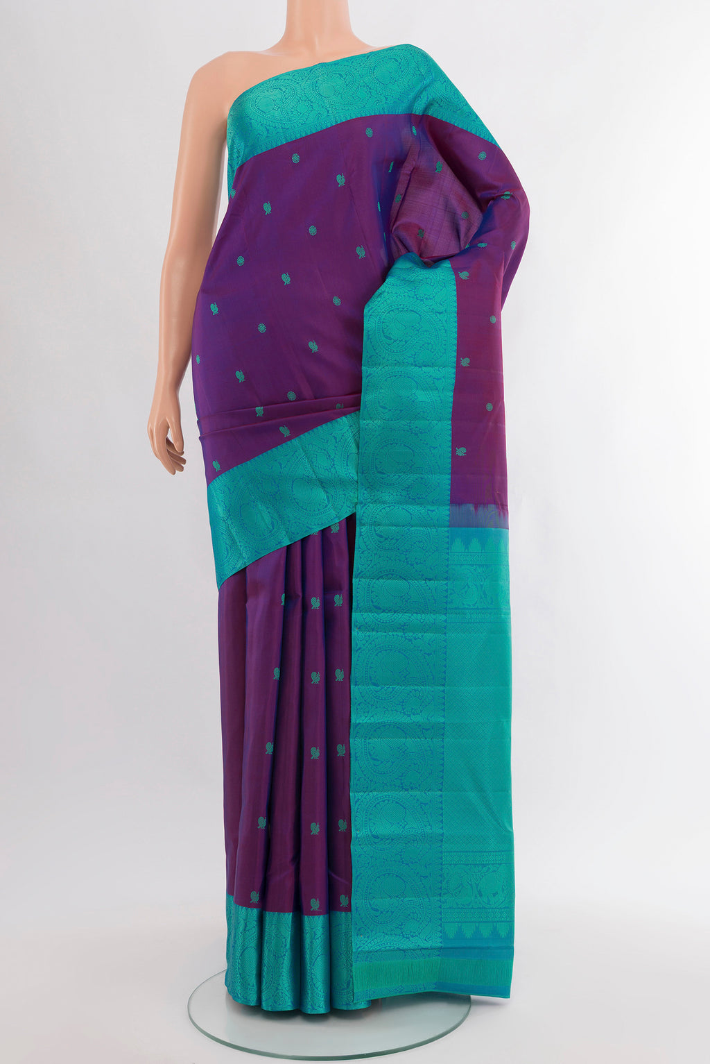 Magenta Kanchipuram Silk Saree with Zari Butta on the body and Silk Border.  displayed on a mannequin