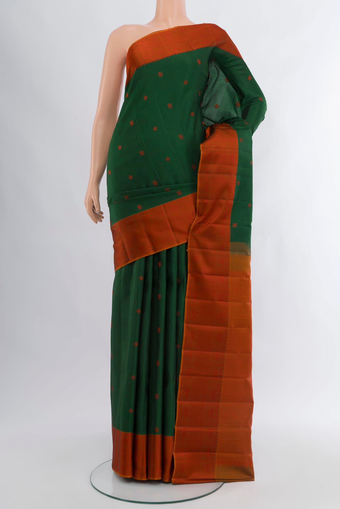 Bottle Green Kanchipuram Silk Saree with Thread Butta on the body and Thread Border.  displayed on a mannequin