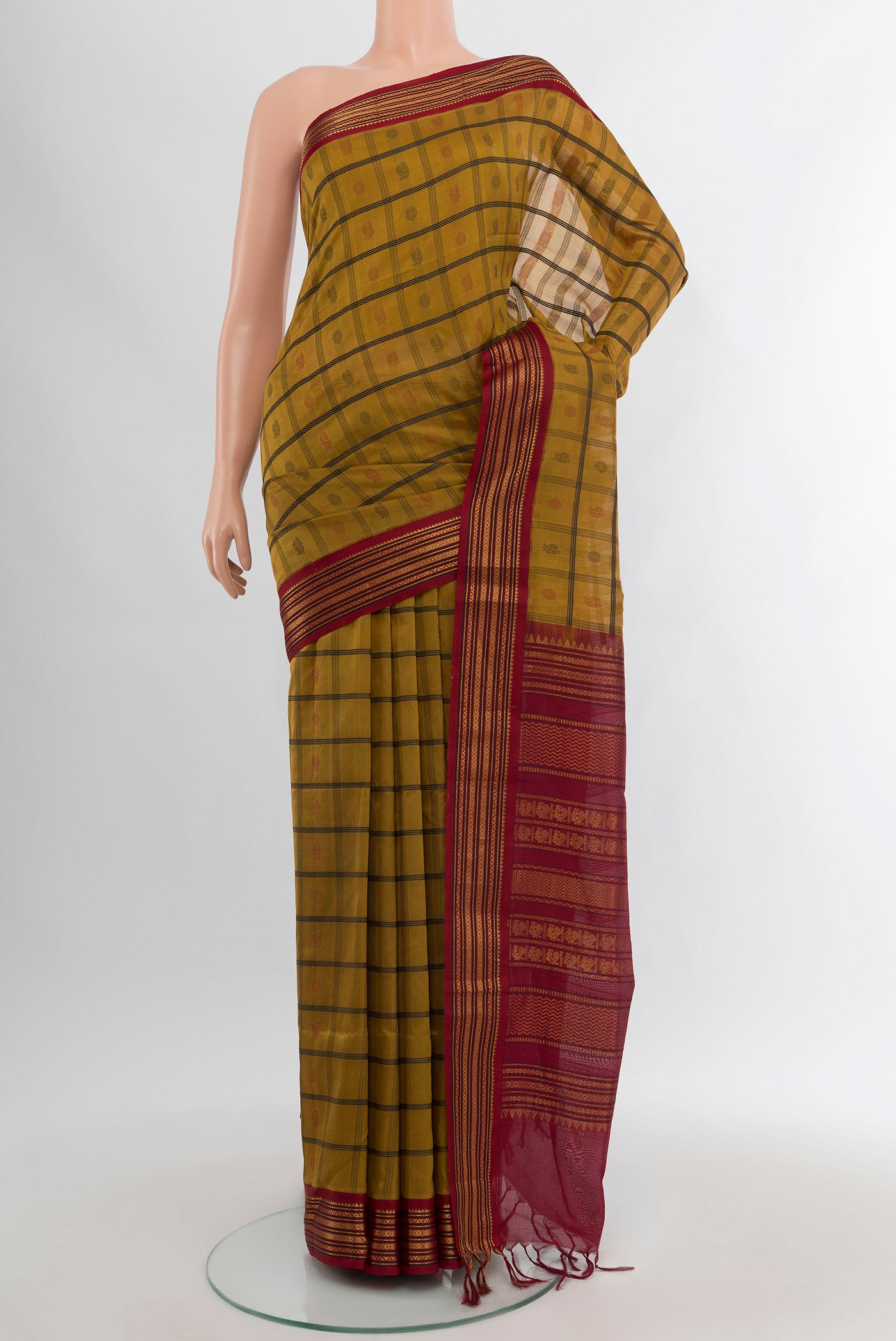 Mehandi Green Silk Cotton Saree with Checked design on the body and Zari Border.  displayed on a mannequin
