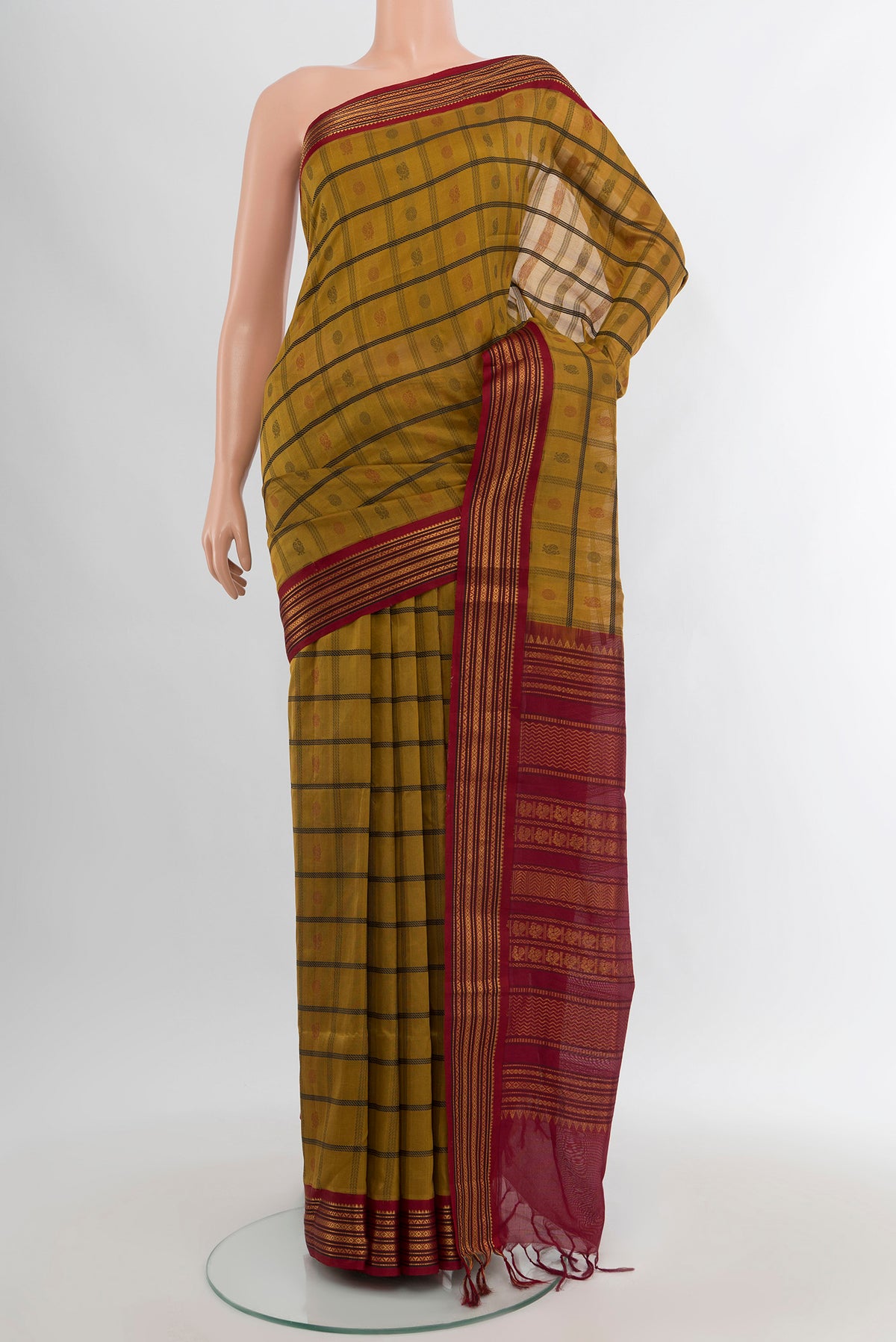 Mehandi Green Silk Cotton Saree with Checked design on the body and Zari Border.  displayed on a mannequin