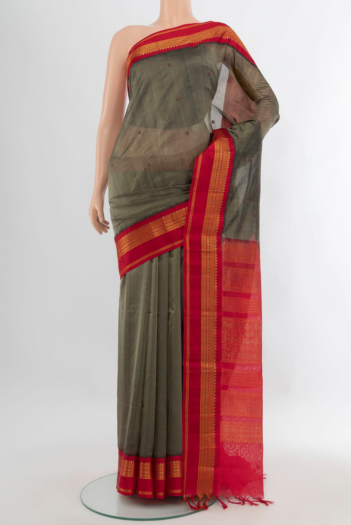 Olive Green Silk Cotton Saree with Thread Butta on the body and Zari Border.  displayed on a mannequin