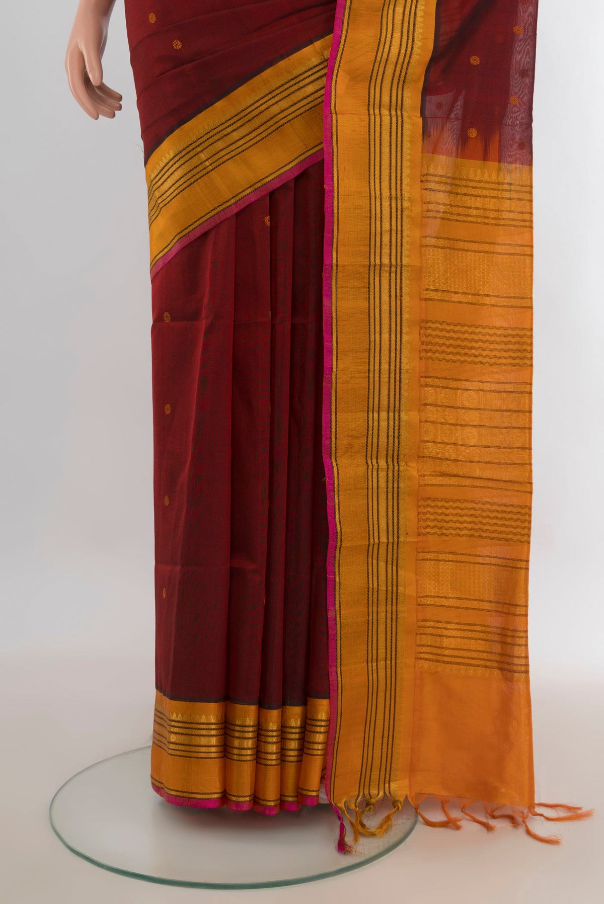 Pleats and pallu of Maroon Silk Cotton Saree with Zari Butta on the body and Silk Border. 