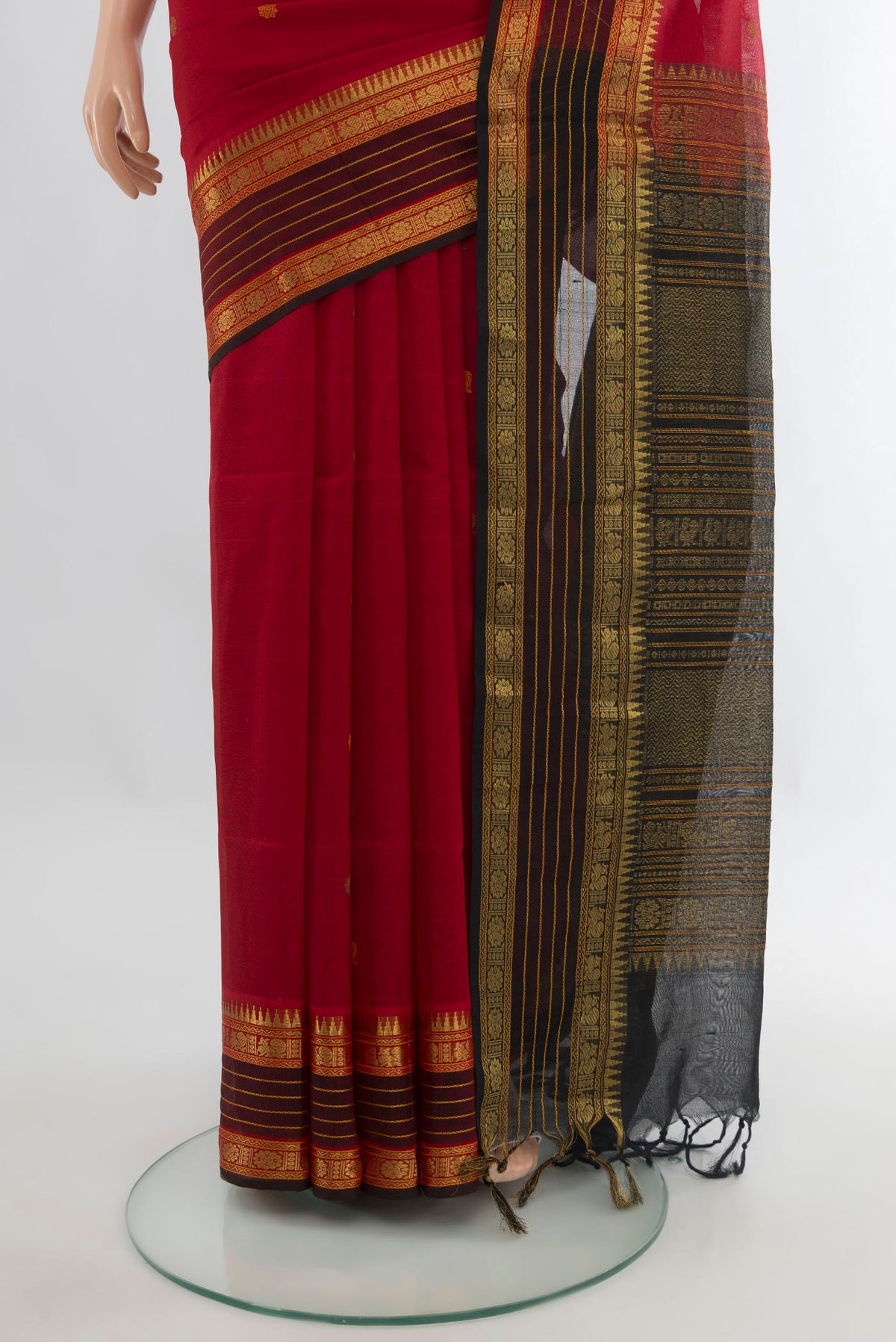Pleats and pallu of Red Silk Cotton Saree with Zari Butta on the body and Zari Border. 