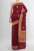 Maroon Banarasi Katan Silk Saree with Zari Butta on the body and Zari Border.  displayed on a mannequin