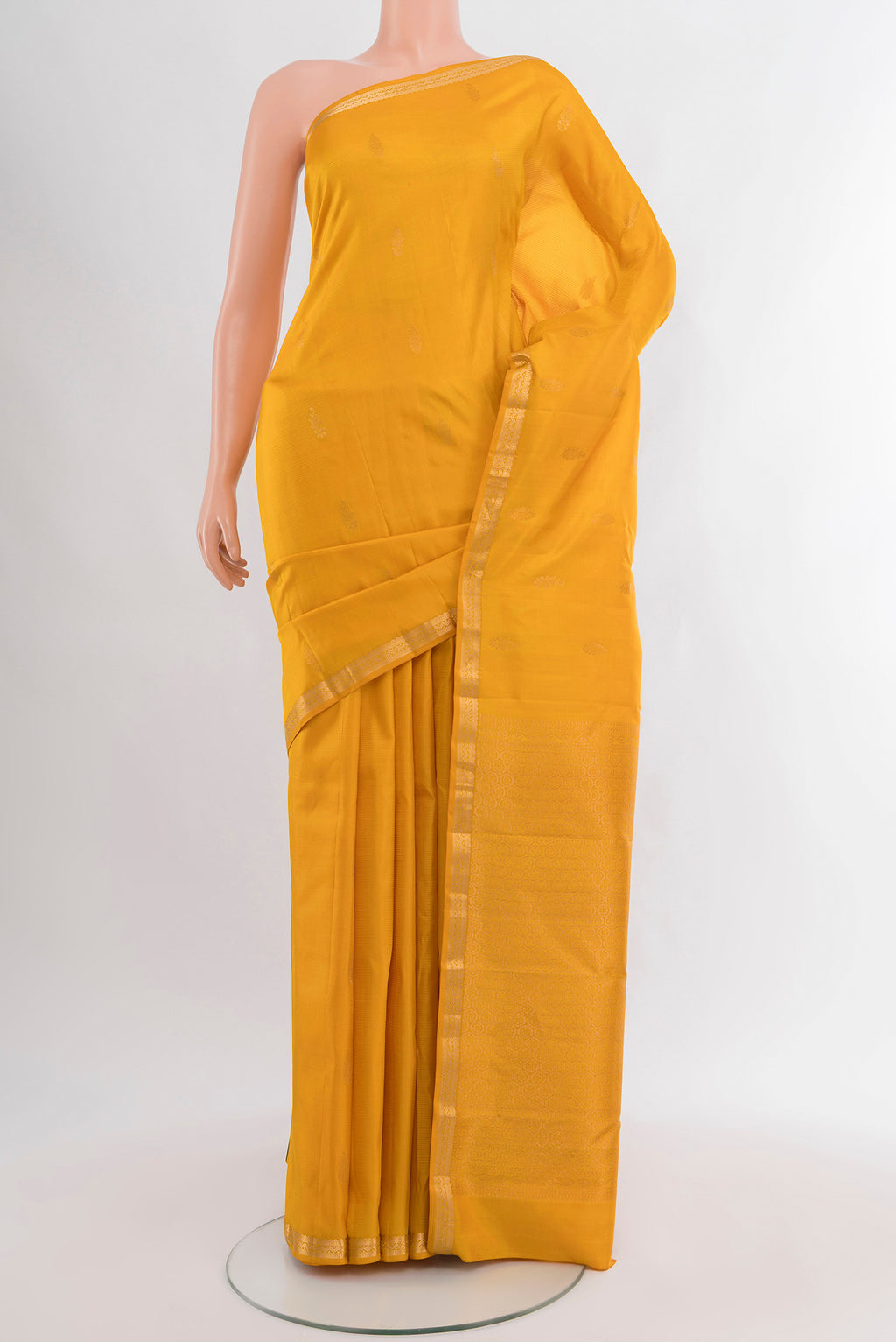 Yellow Kanjivaram Silk Saree with Zari Butta on the body and Zari Border.  displayed on a mannequin