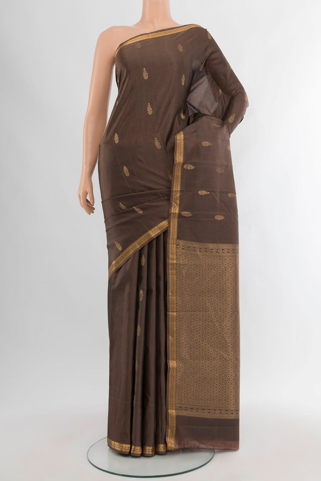 Brown Kanjivaram Silk Saree with Zari Butta on the body and Zari Border.  displayed on a mannequin