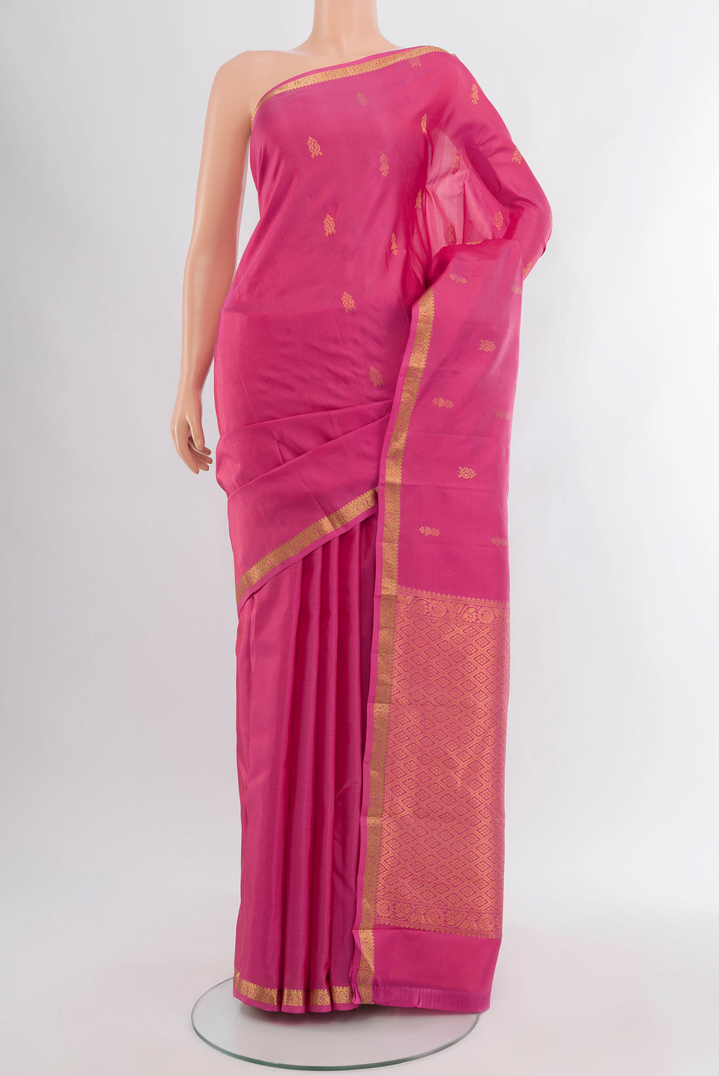Rose pink Kanjivaram Silk Saree with Zari Butta on the body and Zari Border.  displayed on a mannequin