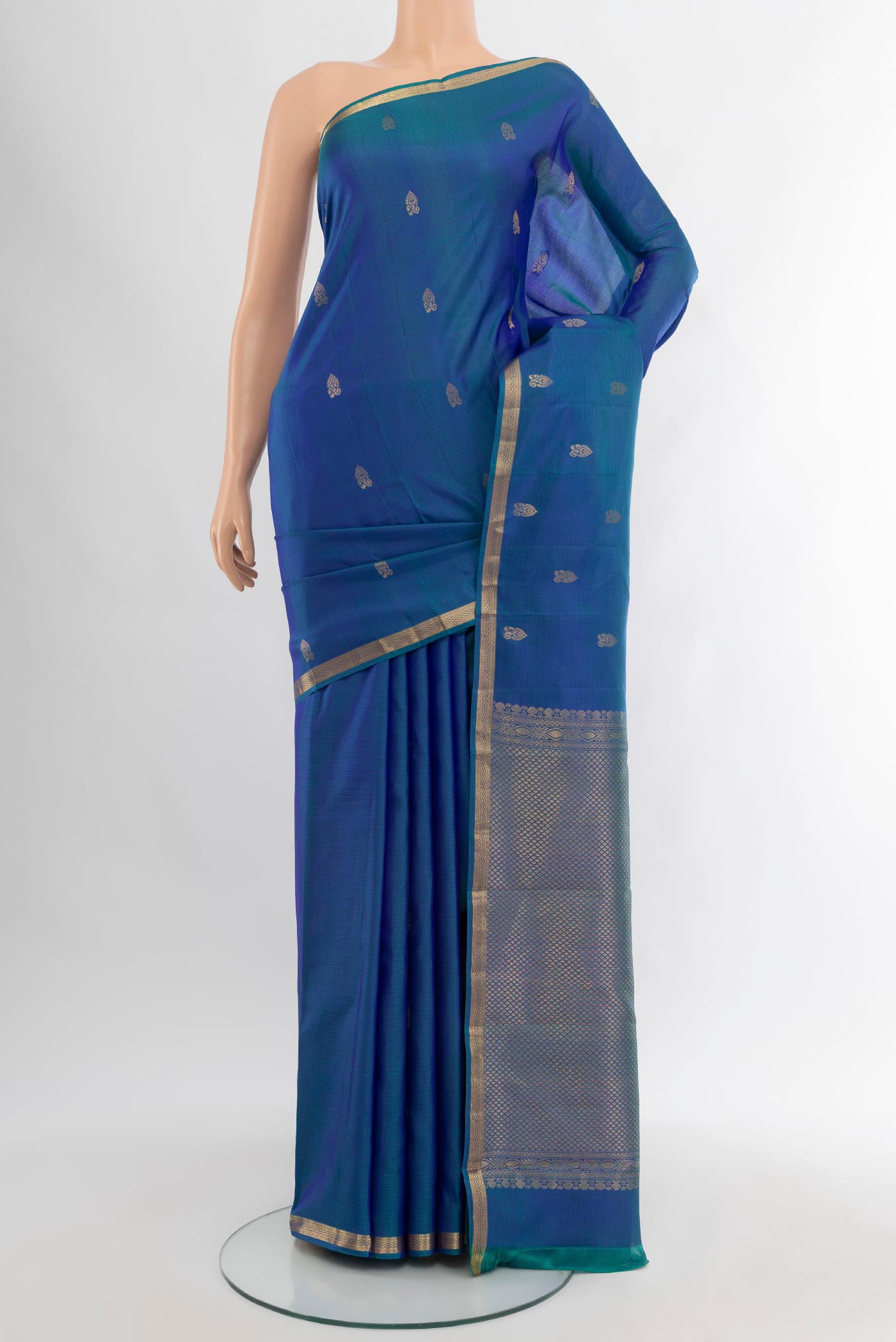 Peacock Blue Kanjivaram Silk Saree with Zari Butta on the body and Zari Border.  displayed on a mannequin