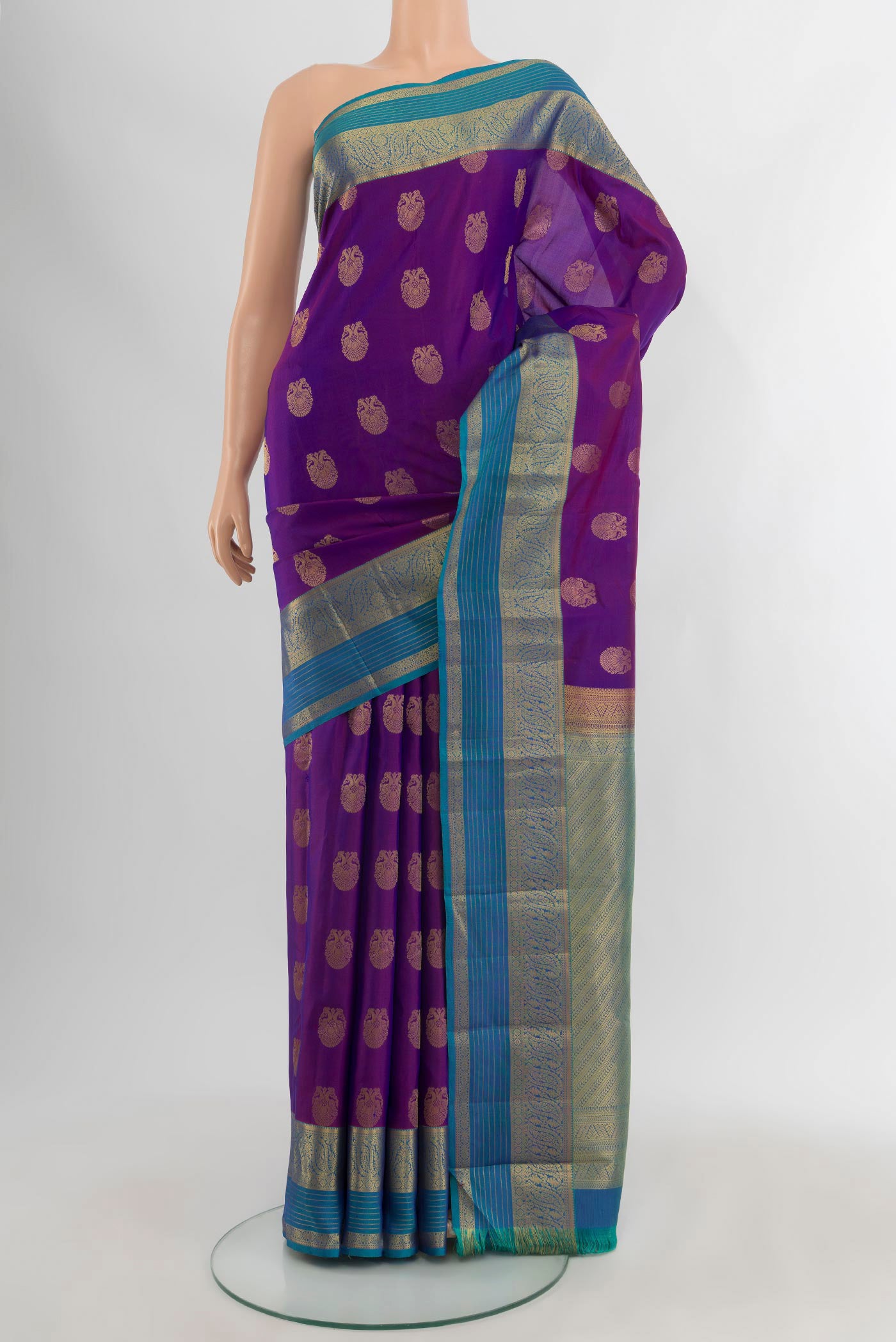 Purple Kanchipuram Silk Saree with Zari Butta on the body and Zari Border.  displayed on a mannequin