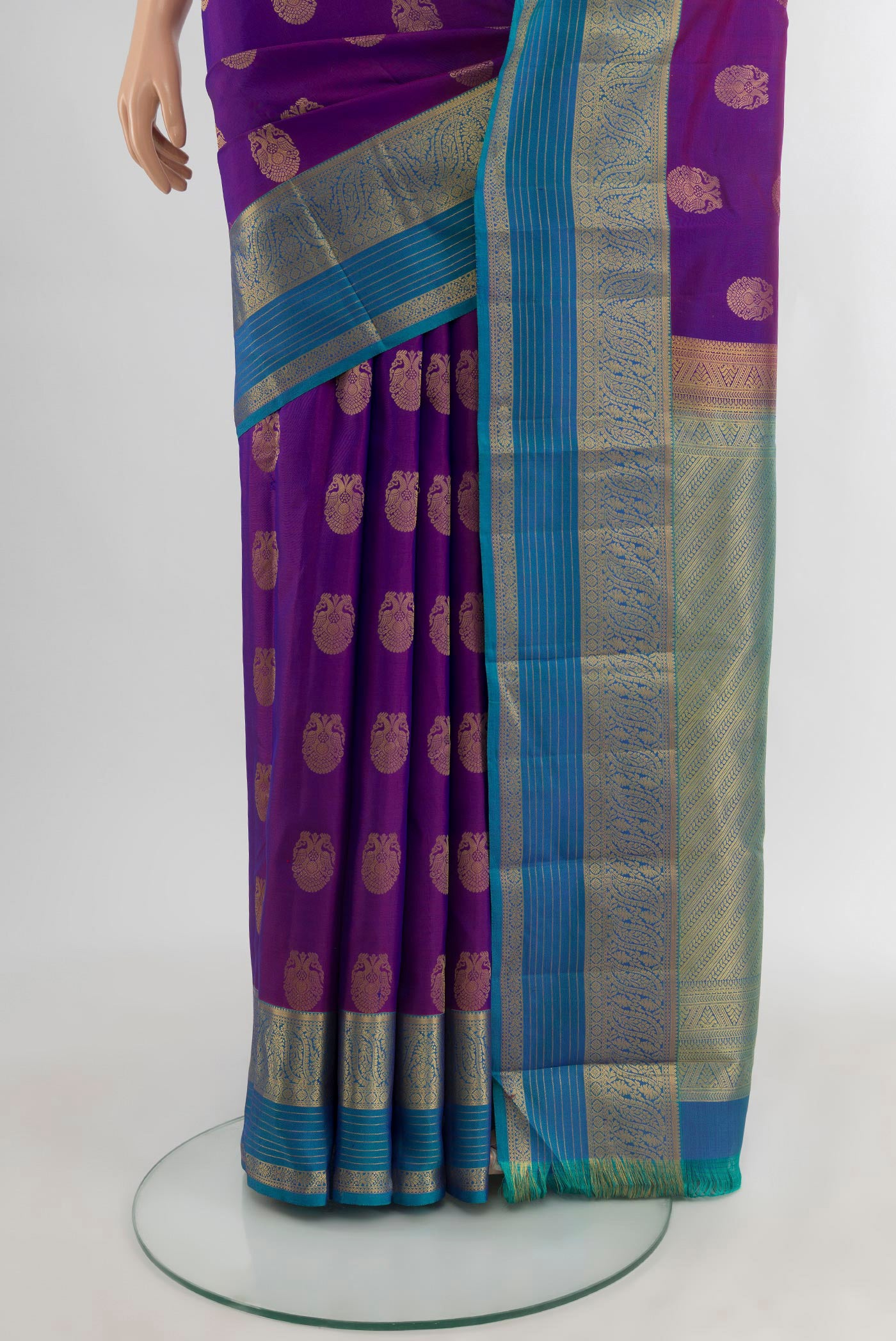 Pleats and pallu of Purple Kanchipuram Silk Saree with Zari Butta on the body and Zari Border. 