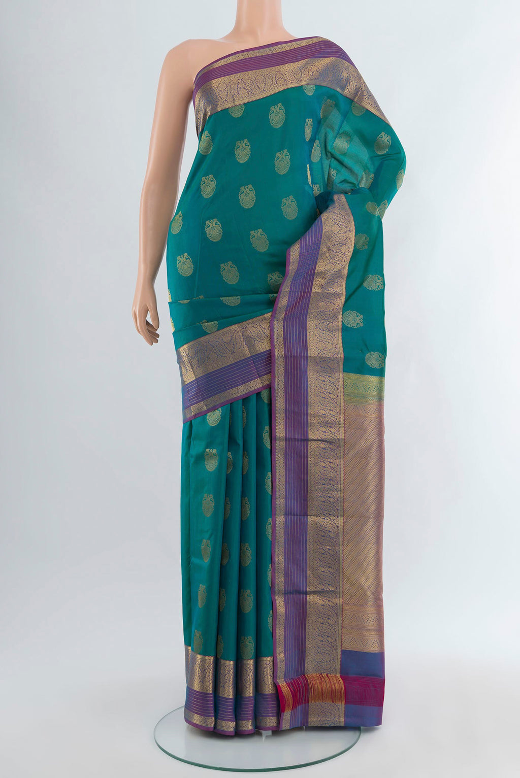 Peacock Blue Kanchipuram Silk Saree with Zari Butta on the body and Zari Border.  displayed on a mannequin
