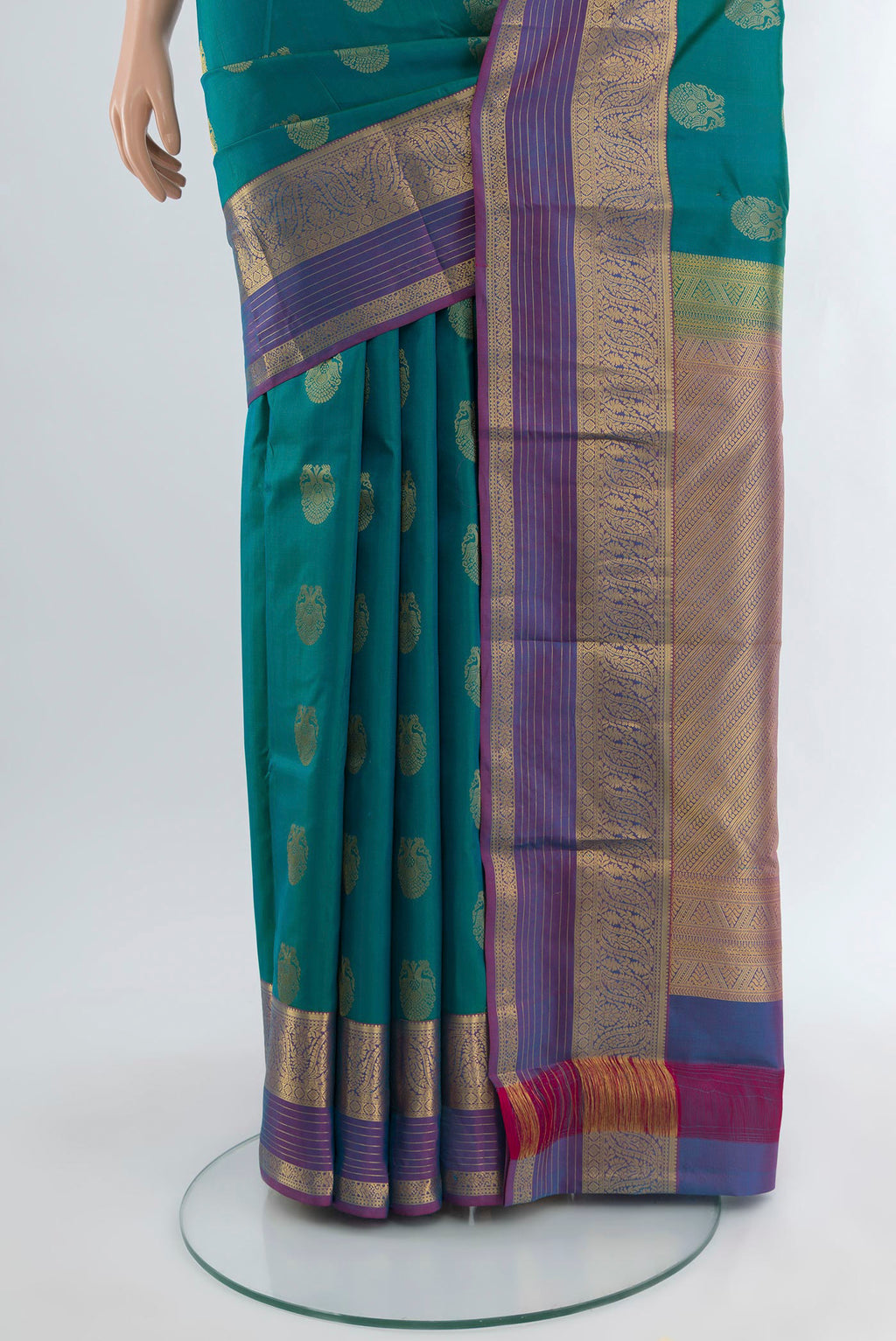 Pleats and pallu of Peacock Blue Kanchipuram Silk Saree with Zari Butta on the body and Zari Border. 