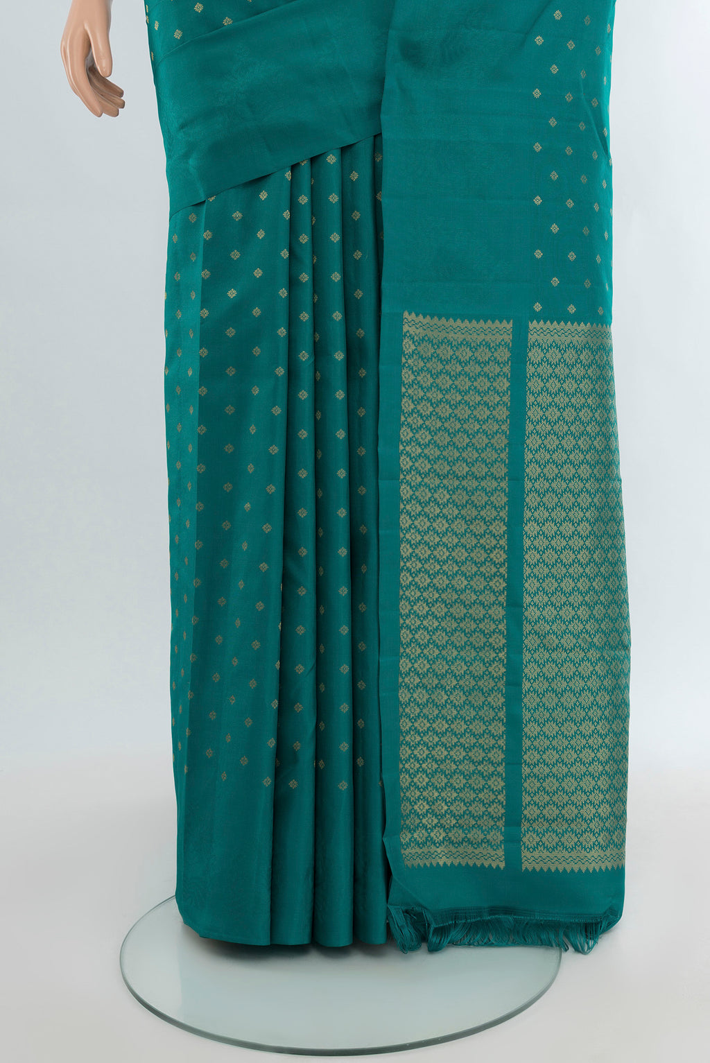 Pleats and pallu of Peacock Blue Kanchipuram Silk Saree with Zari Butta on the body and Without Border. 