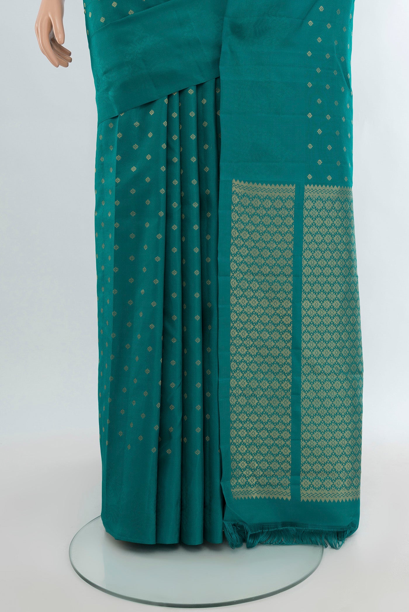Pleats and pallu of Peacock Blue Kanchipuram Silk Saree with Zari Butta on the body and Without Border. 