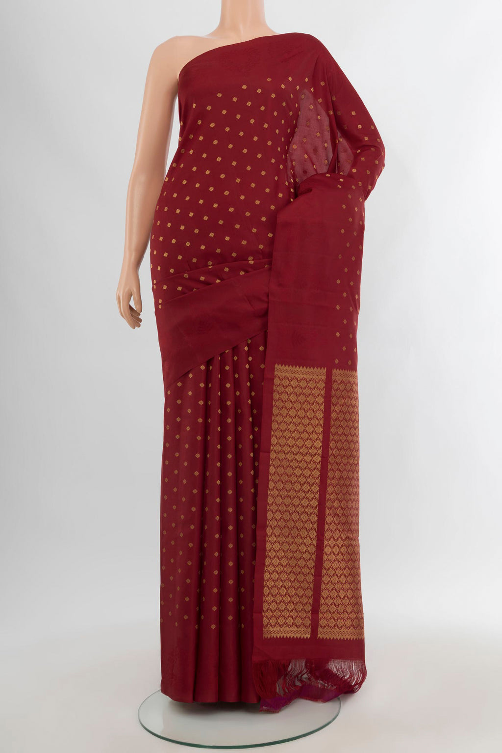 Maroon Kanchipuram Silk Saree with Zari Butta on the body and Plain Border.  displayed on a mannequin