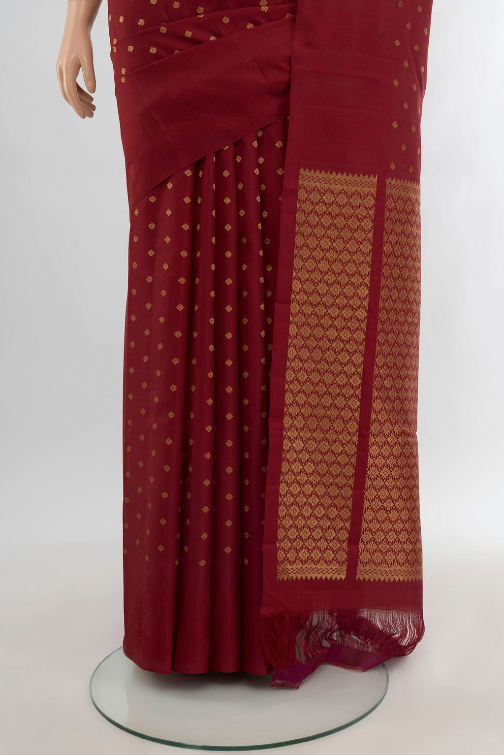Pleats and pallu of Maroon Kanchipuram Silk Saree with Zari Butta on the body and Plain Border. 