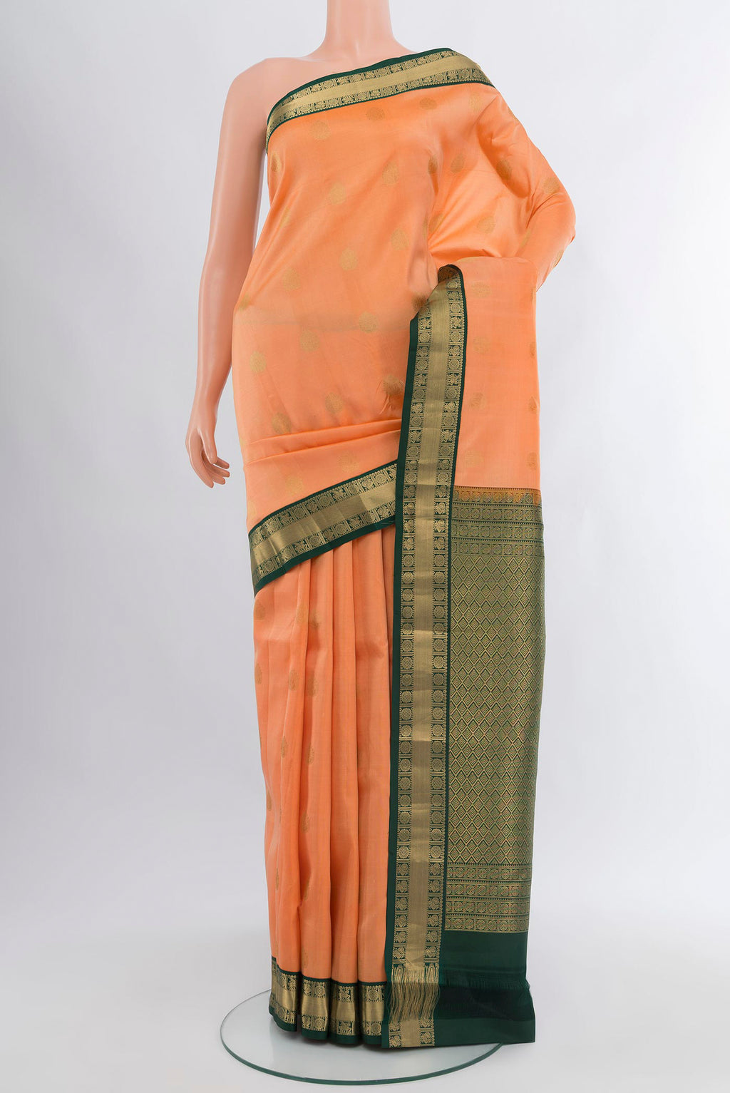 Peach Kanchipuram Silk Saree with Zari Butta on the body and Zari Border.  displayed on a mannequin