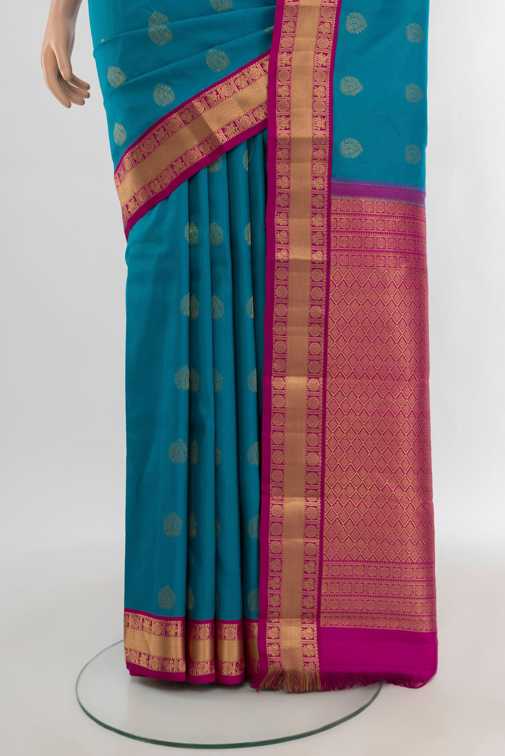 Pleats and pallu of Peacock Blue Kanchipuram Silk Saree with Zari Butta on the body and Zari Border. 