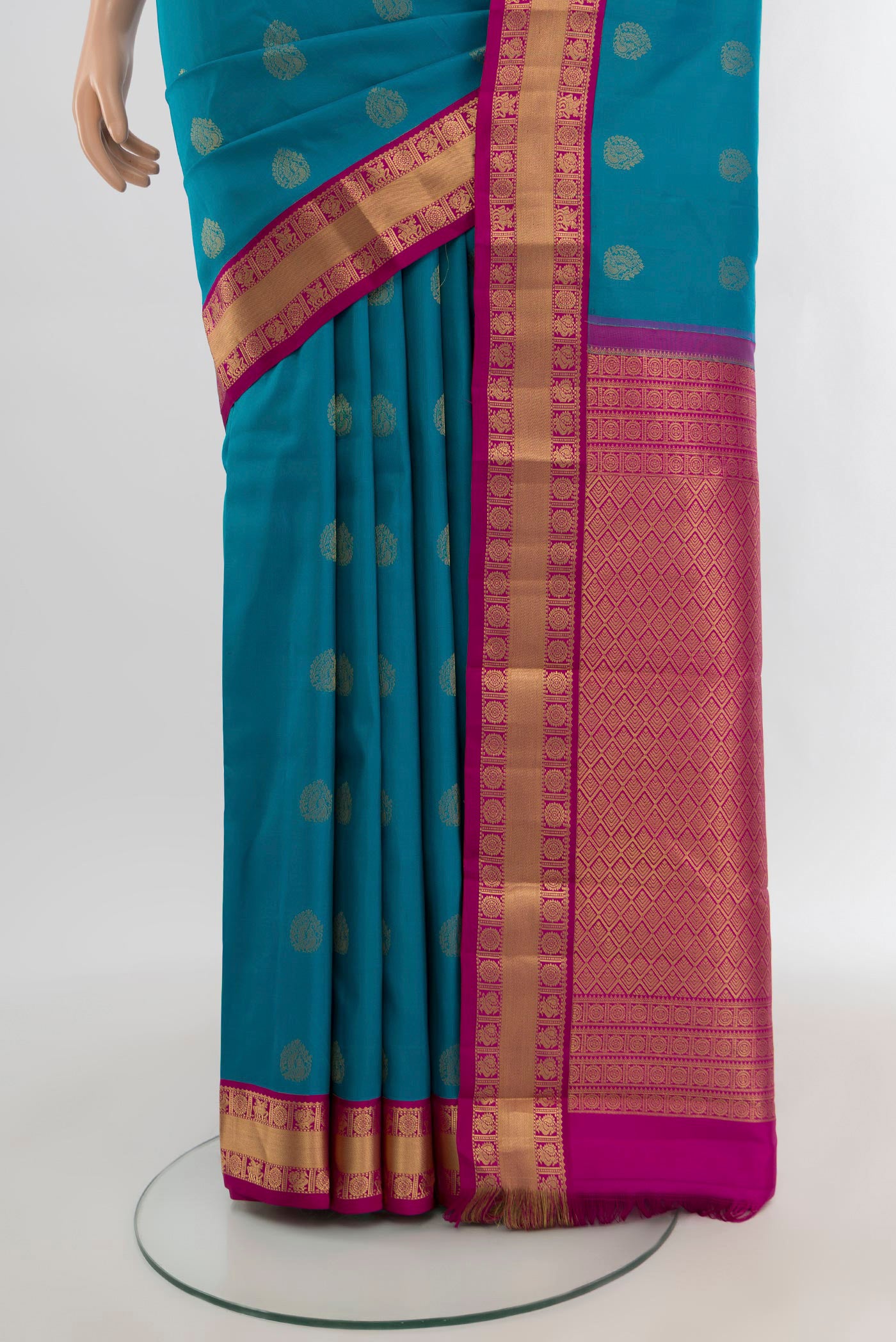 Pleats and pallu of Peacock Blue Kanchipuram Silk Saree with Zari Butta on the body and Zari Border. 