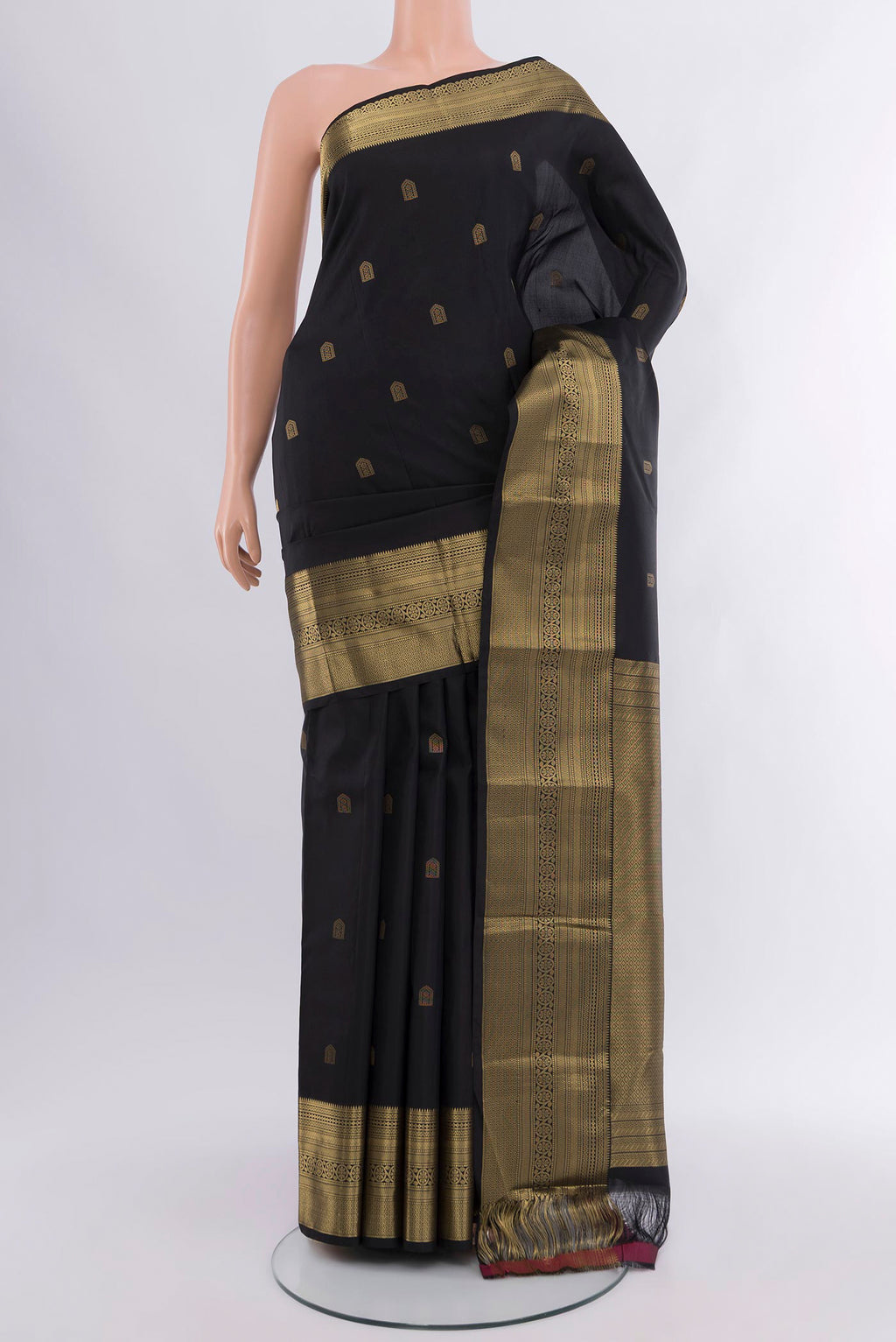 Black Kanchipuram Silk Saree with Zari Butta on the body and Zari Border.  displayed on a mannequin