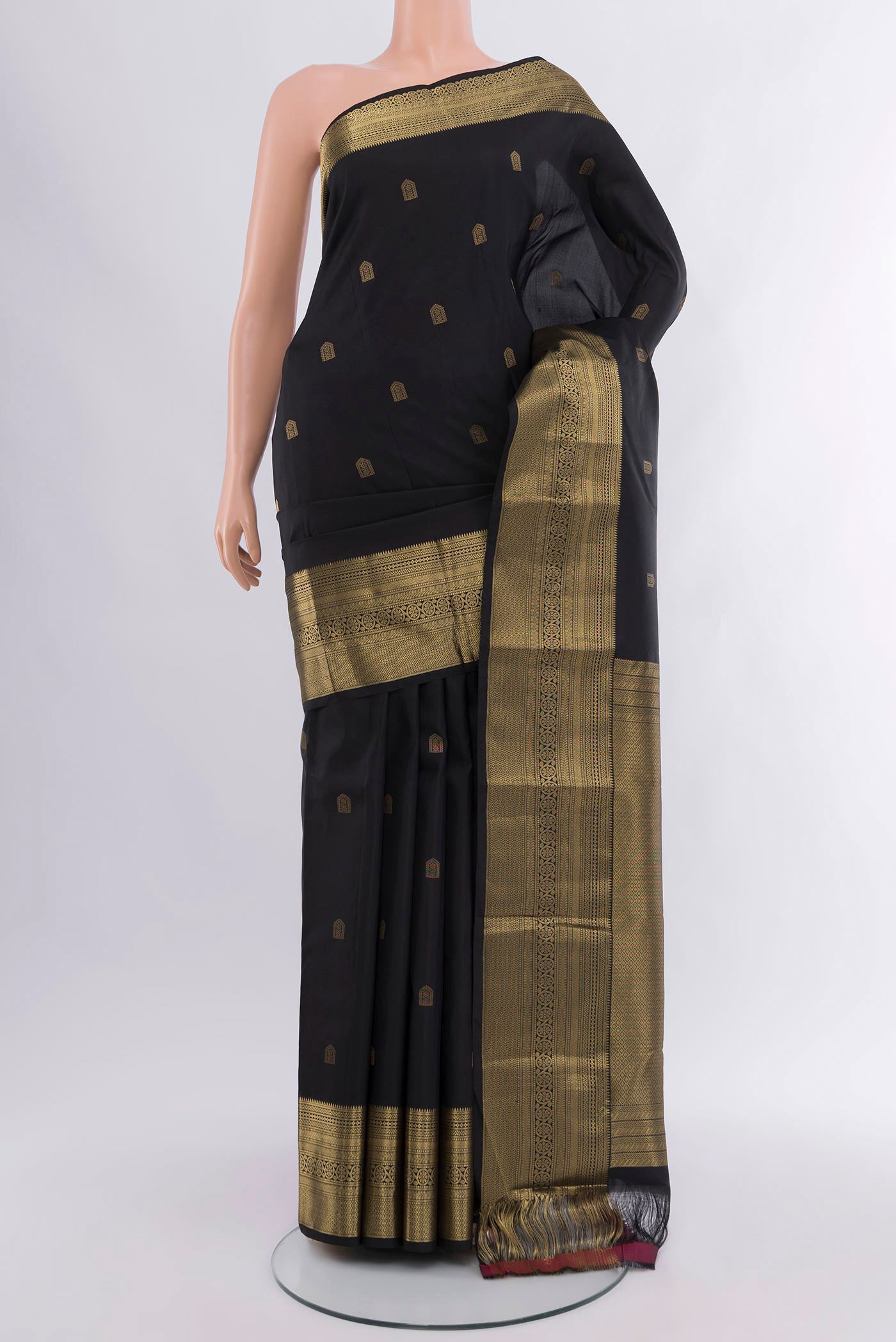 Black Kanchipuram Silk Saree with Zari Butta on the body and Zari Border.  displayed on a mannequin