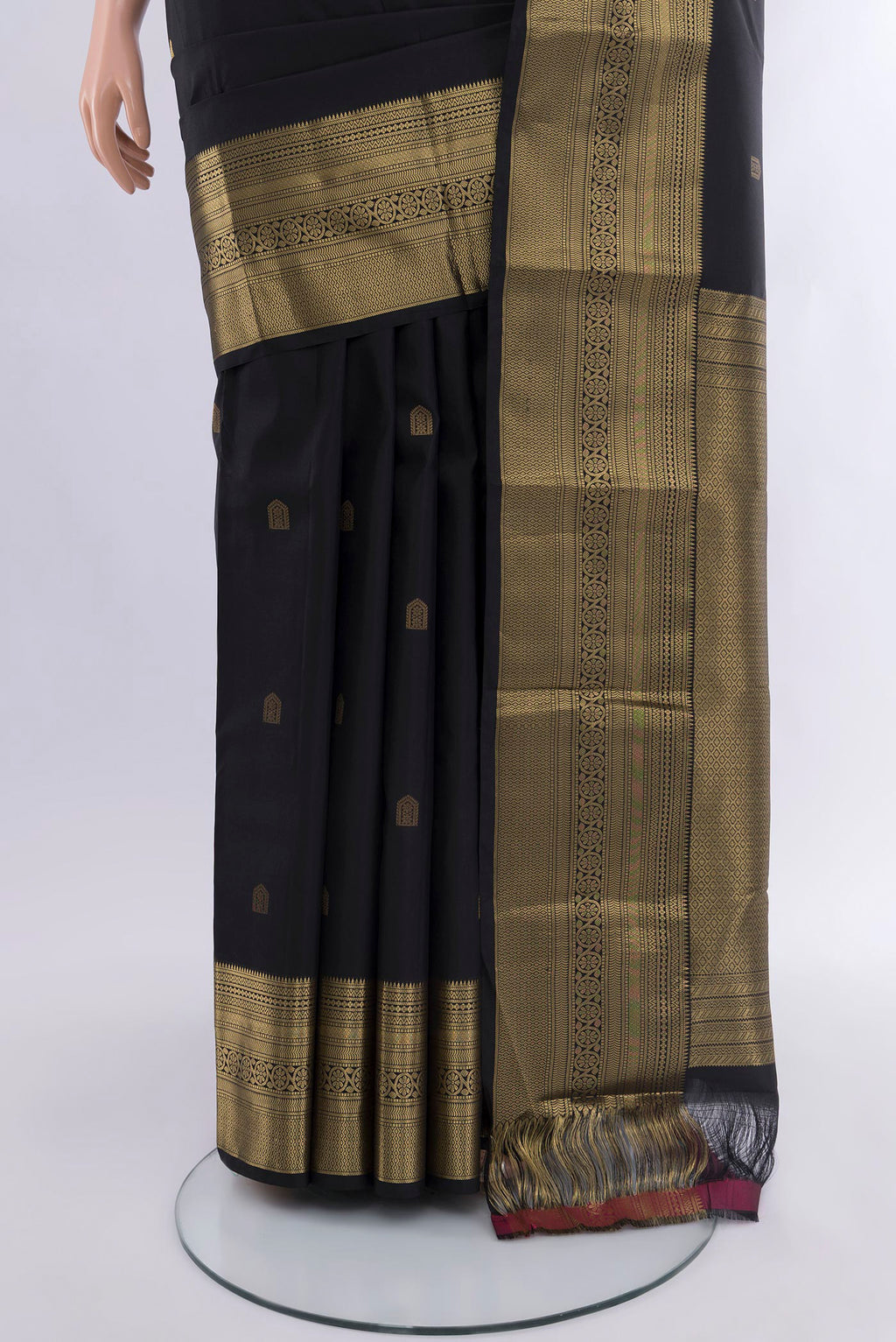Pleats and pallu of Black Kanchipuram Silk Saree with Zari Butta on the body and Zari Border. 