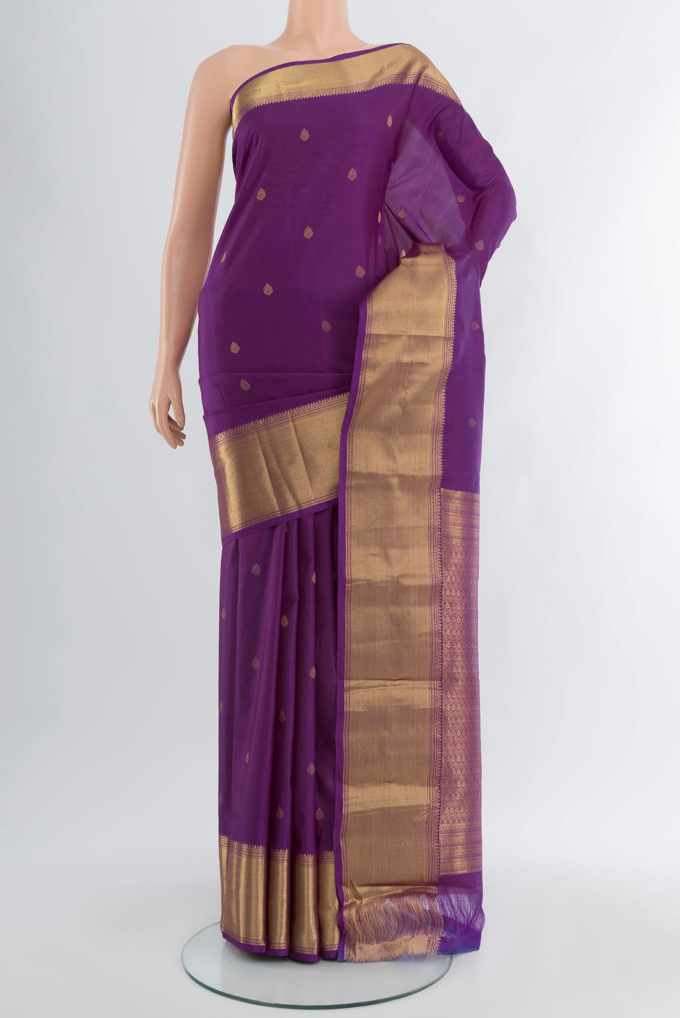 Violet Kanchipuram Silk Saree with Zari Butta on the body and Zari Border.  displayed on a mannequin
