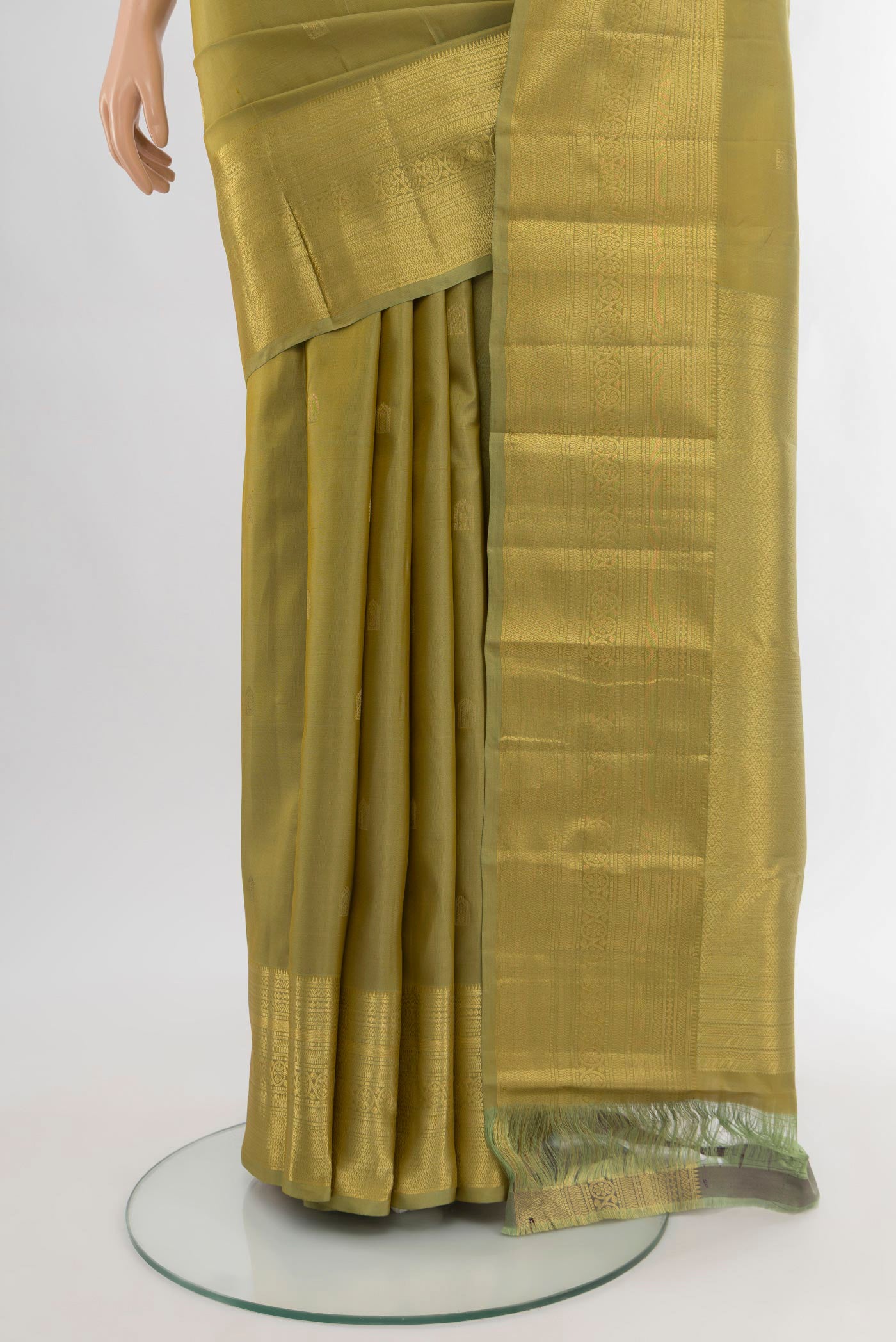 Pleats and pallu of Mehandi Green Kanchipuram Silk Saree with Zari Butta on the body and Zari Border. 