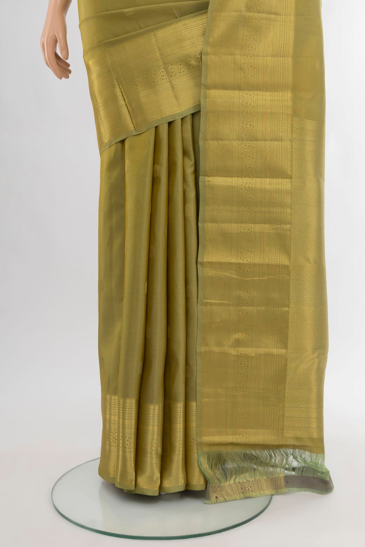 Pleats and pallu of Mehandi Green Kanchipuram Silk Saree with Zari Butta on the body and Zari Border. 