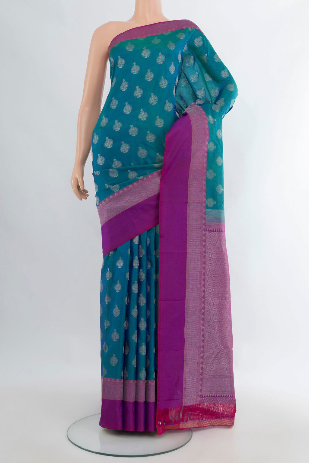 Pure Silk Peacock Blue Kanchipuram Saree with Zari Butta on the body and Zari Border.  displayed on a mannequin