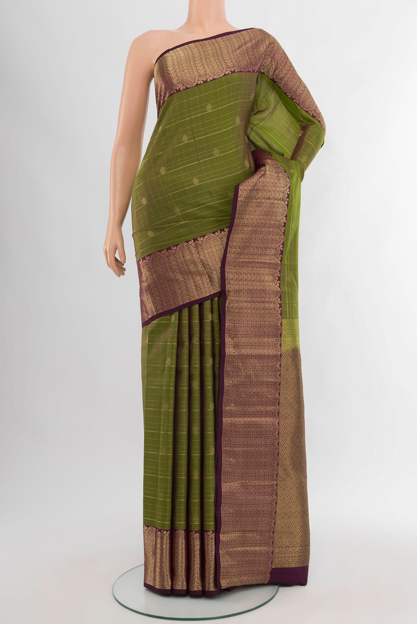Mehandi Green Kanjivaram Silk Saree with Checked design on the body and Zari Border.  displayed on a mannequin