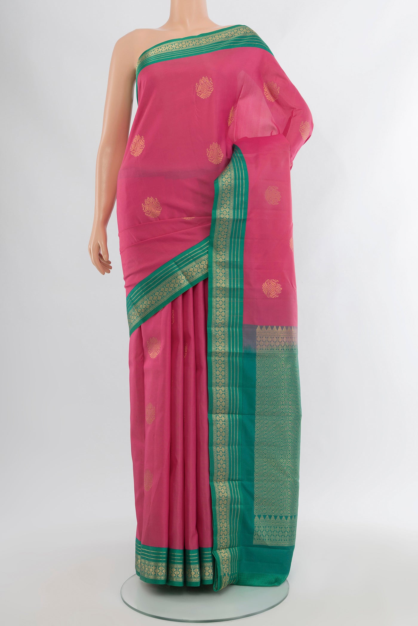 Bronze Kanchipuram Silk Saree with Zari Butta on the body and Silk Border.  displayed on a mannequin