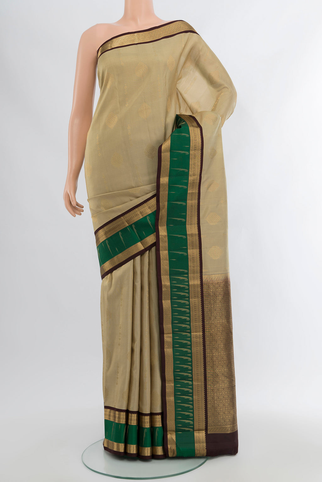 Beige Kanjivaram Silk Saree with Zari Butta on the body and Zari Border.  displayed on a mannequin