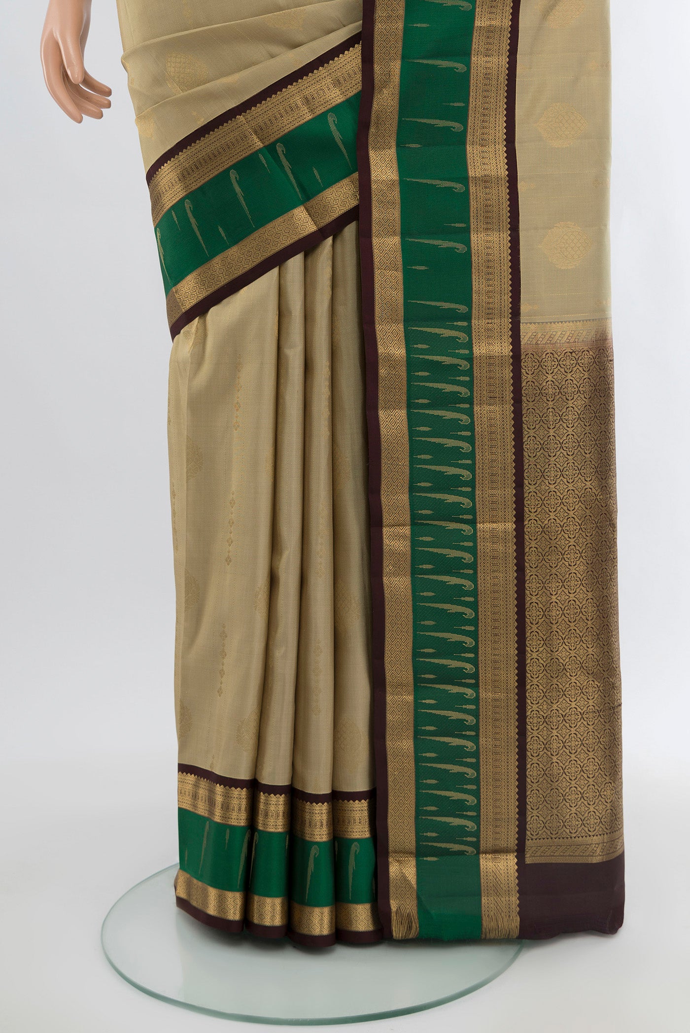 Pleats and pallu of Beige Kanjivaram Silk Saree with Zari Butta on the body and Zari Border. 