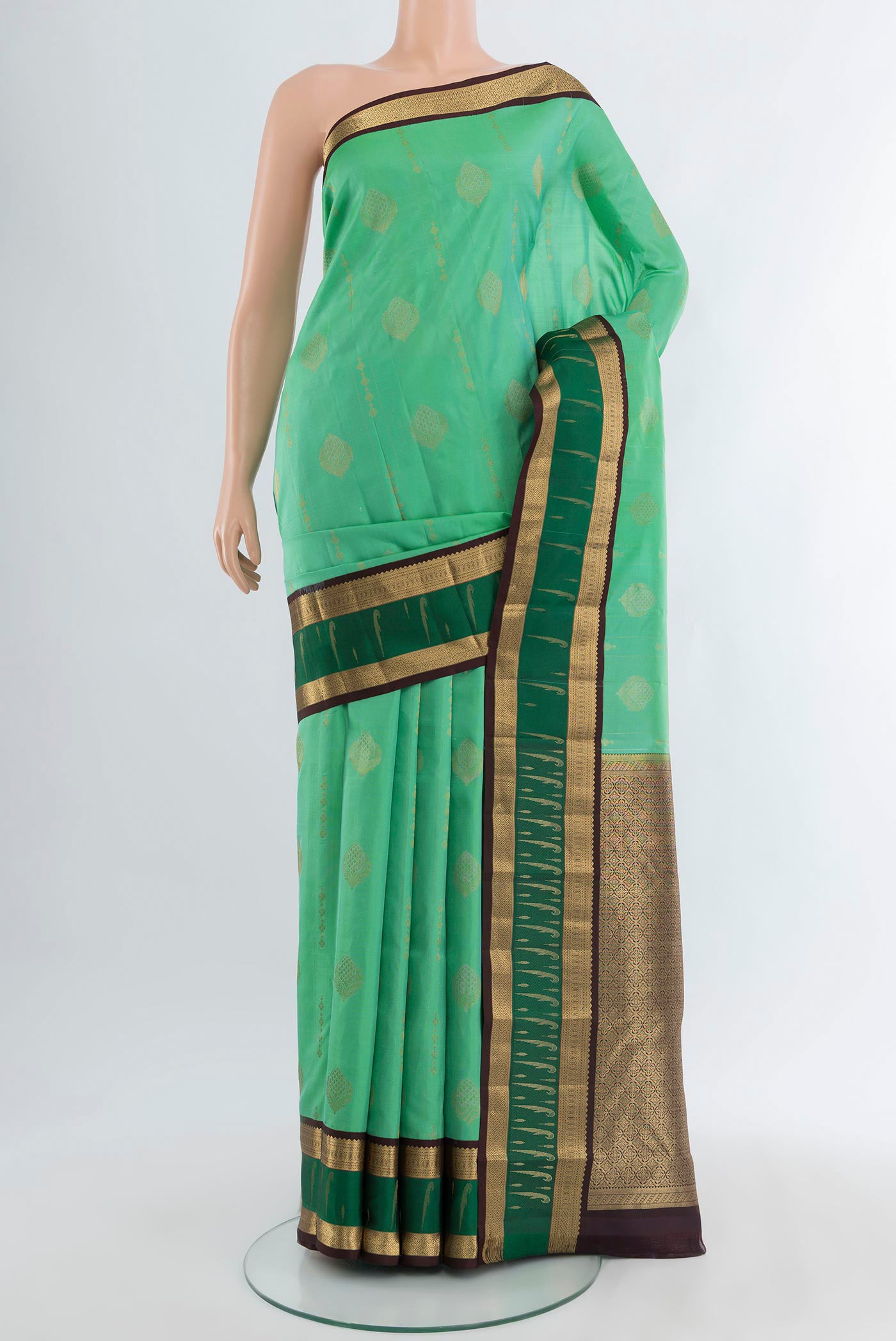 Sea Green Kanjivaram Silk Saree with Zari Butta on the body and Zari Border.  displayed on a mannequin