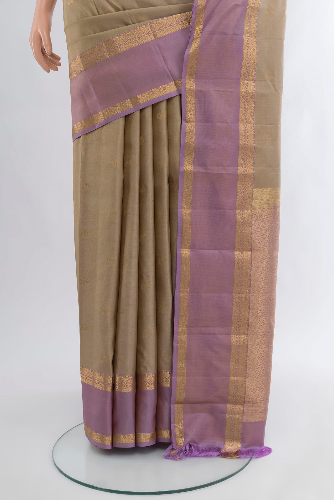 Pleats and pallu of Beige Kanchipuram Silk Saree with Zari Butta on the body and Zari Border. 