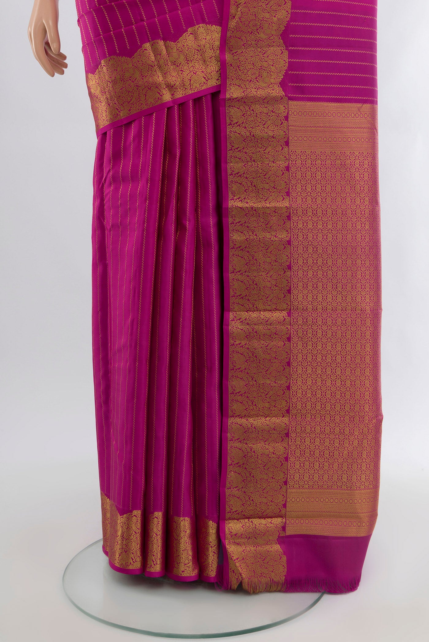 Pleats and pallu of Rani Pink Kanchipuram Silk Saree with Stripes on the body and Zari Border. 