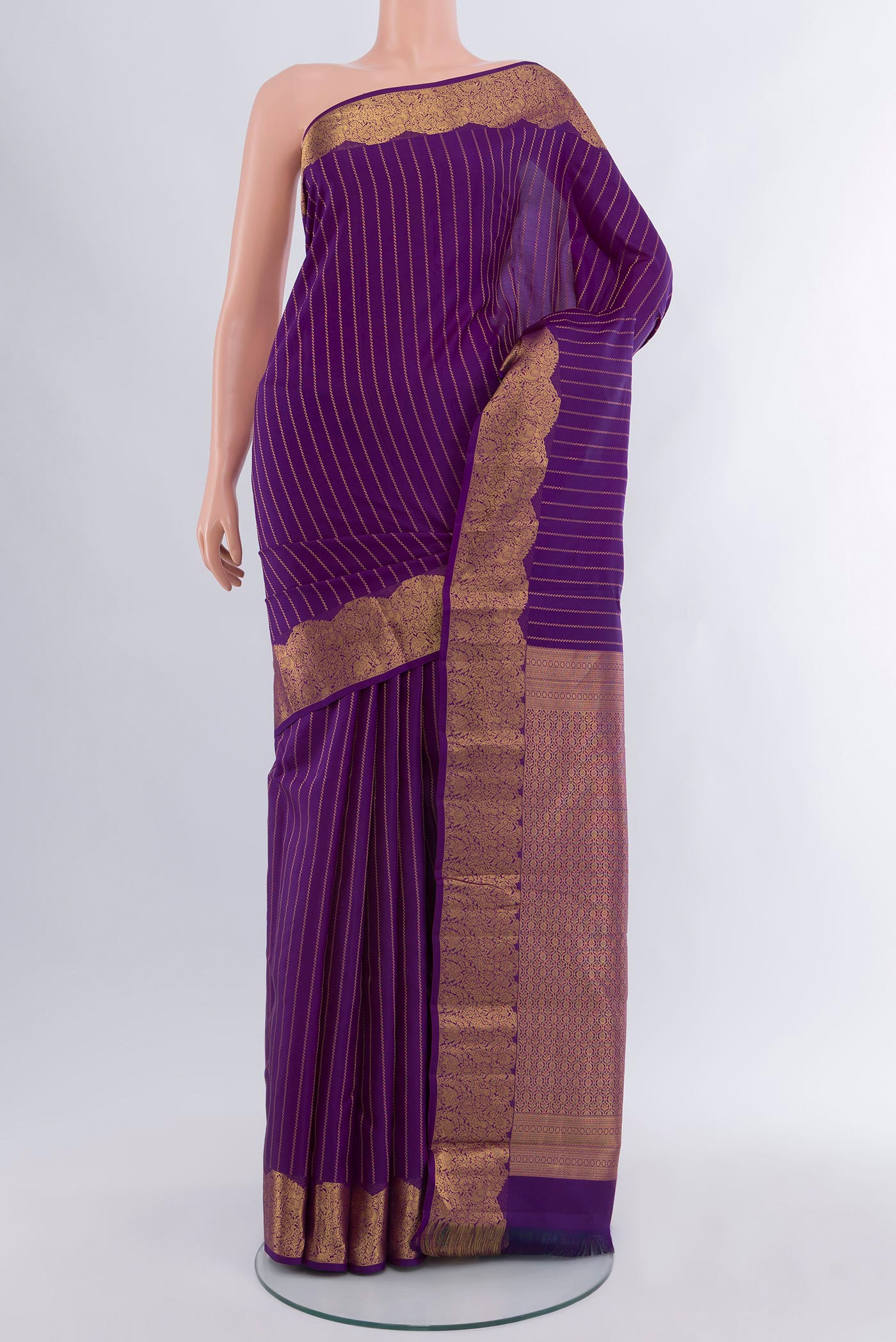 Violet Kanchipuram Silk Saree with Stripes on the body and Zari Border.  displayed on a mannequin