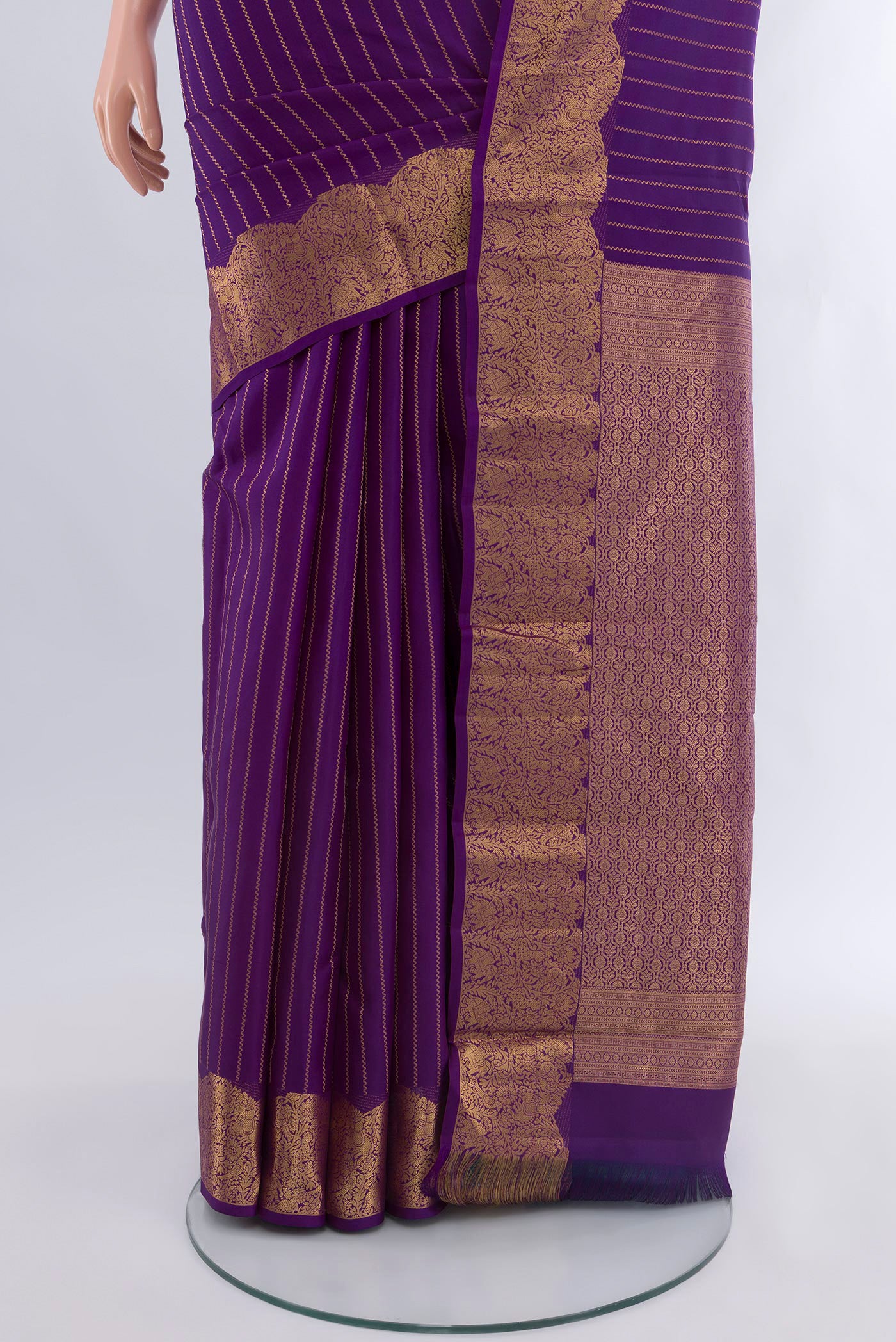 Pleats and pallu of Violet Kanchipuram Silk Saree with Stripes on the body and Zari Border. 