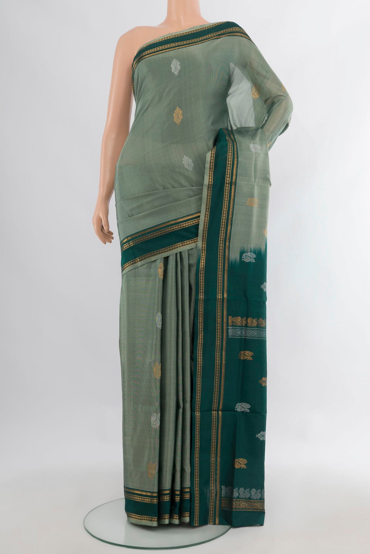 Pure Silk Sage Green Uppada Saree with Zari Butta on the body and Zari Border.  displayed on a mannequin