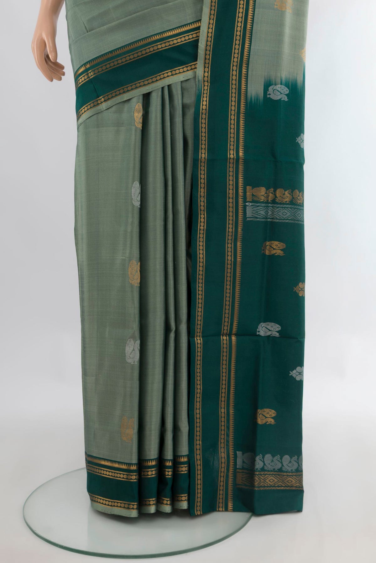 Pleats and pallu of Pure Silk Sage Green Uppada Saree with Zari Butta on the body and Zari Border. 
