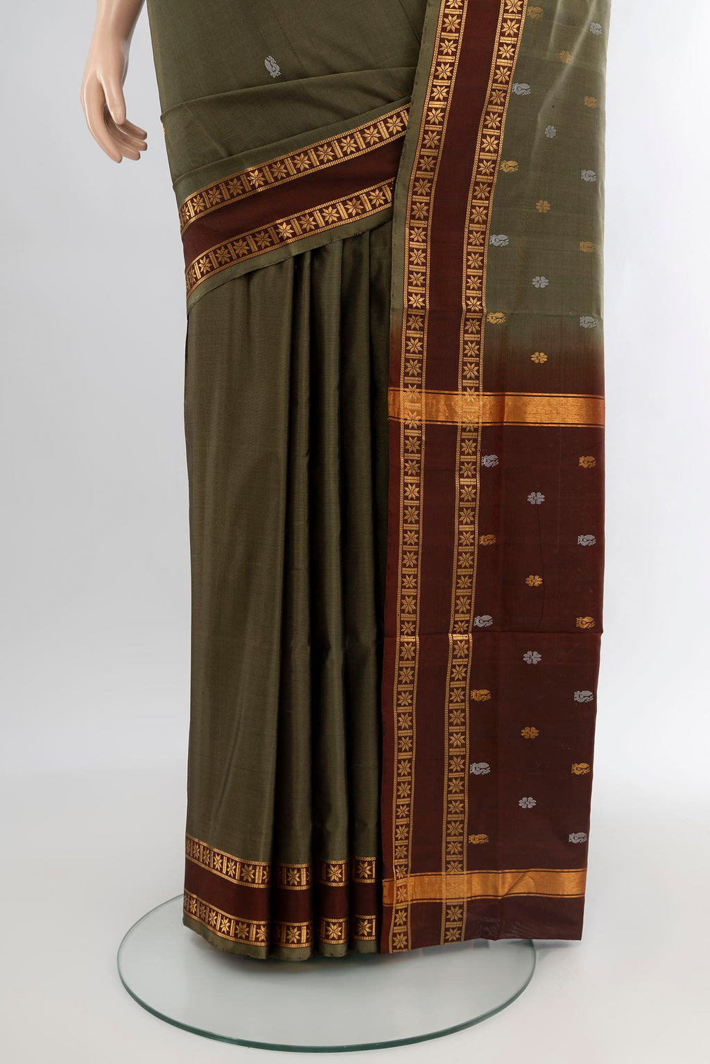 Pleats and pallu of Mehandi Green Uppada Silk Saree with Zari Butta on the body and Zari Border. 
