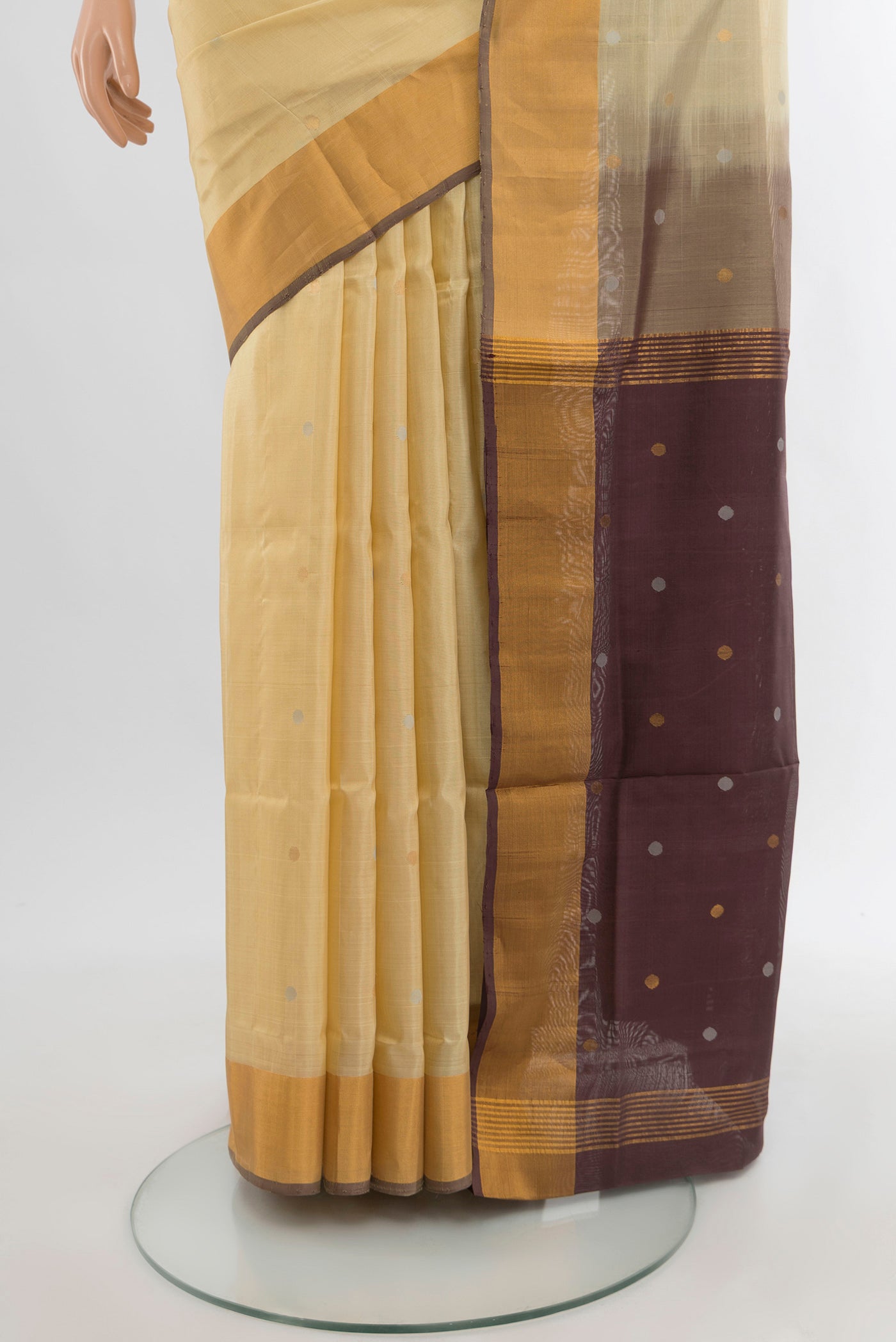 Pleats and pallu of Cream Uppada Silk Saree with Zari Butta on the body and Silk Border. 