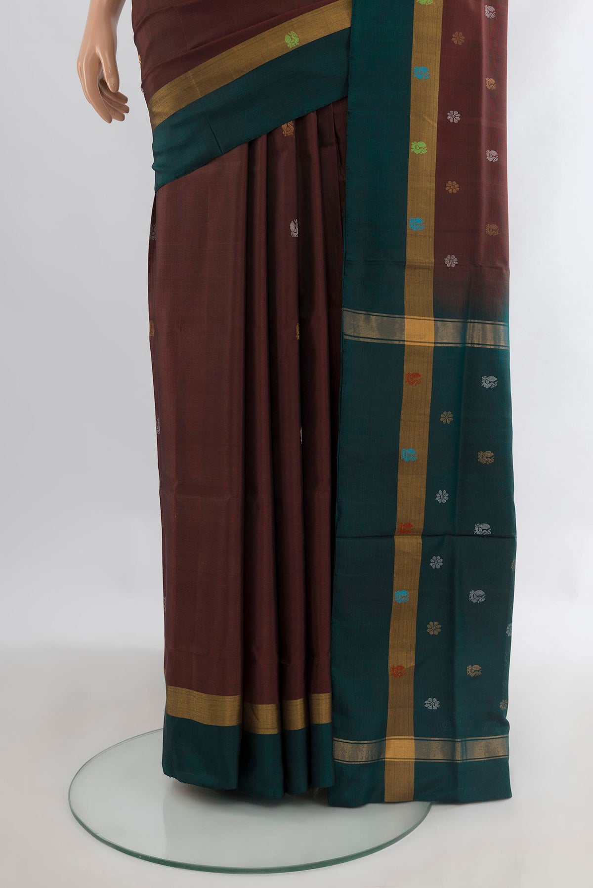 Pleats and pallu of Pure Silk Coffee Brown Uppada Saree with Zari Butta on the body and Plain Border. 
