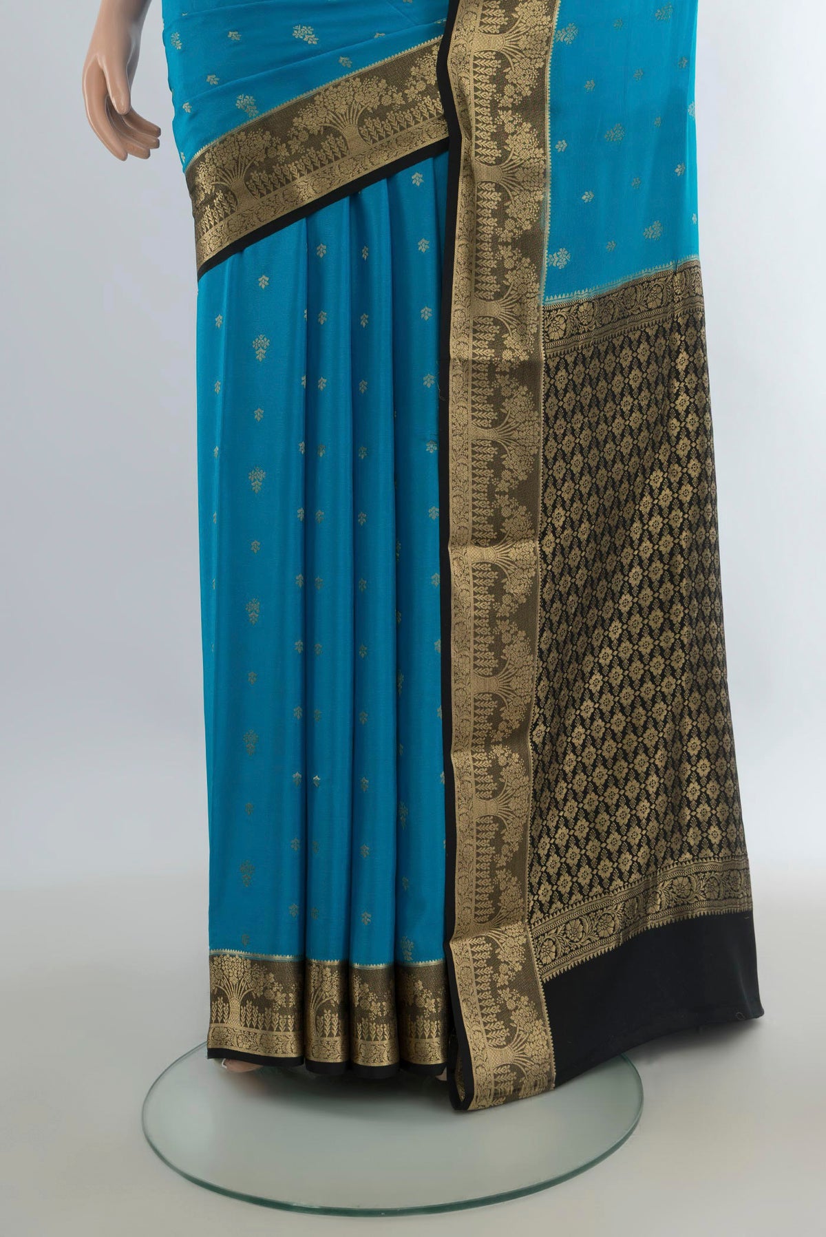Pleats and pallu of Light Blue Mysore Crepe Saree with Zari Butta on the body and Zari Border. 